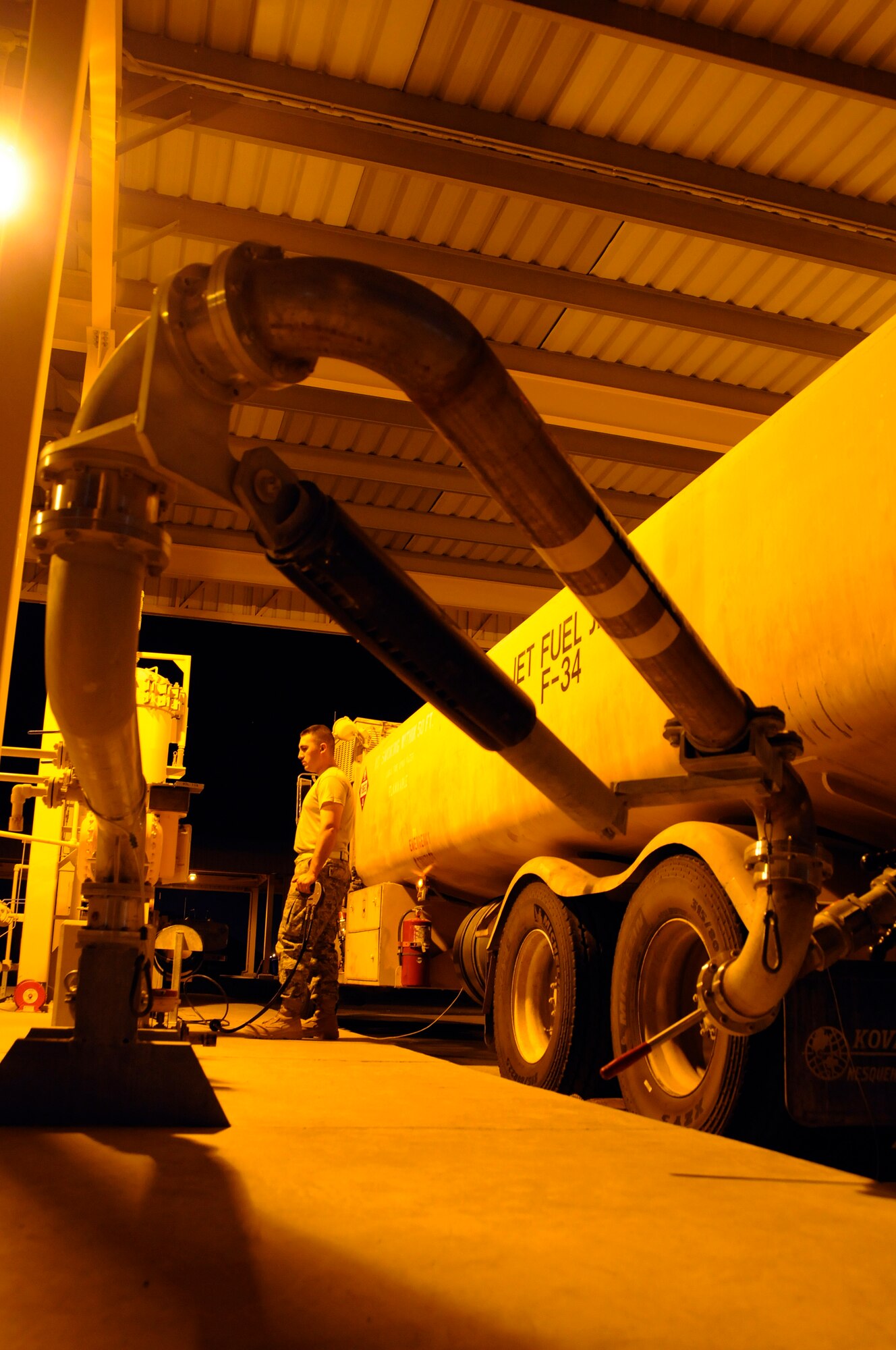 Airman 1st Class David McNabb, 379th Expeditionary Logistics Readiness Squadron, watches the numbers as the gallons rush into his fuel truck October 7, 2008.  Working the night shift is in no way slow as Airman McNabb fills his truck for the first of many times tonight at an undisclosed air base in Southwest Asia.  The fuel teams do their jobs night and day, keeping the jets fueled and ready to fly whenever the mission calls for them.  Airman McNabb, a native of Ontario, Calif., is deployed from Dover Air Force Base, Del., in support of Operations Iraqi and Enduring Freedom and Joint Task Force-Horn of Africa.  (U.S. Air Force photo by Tech. Sgt. Michael Boquette/Released)