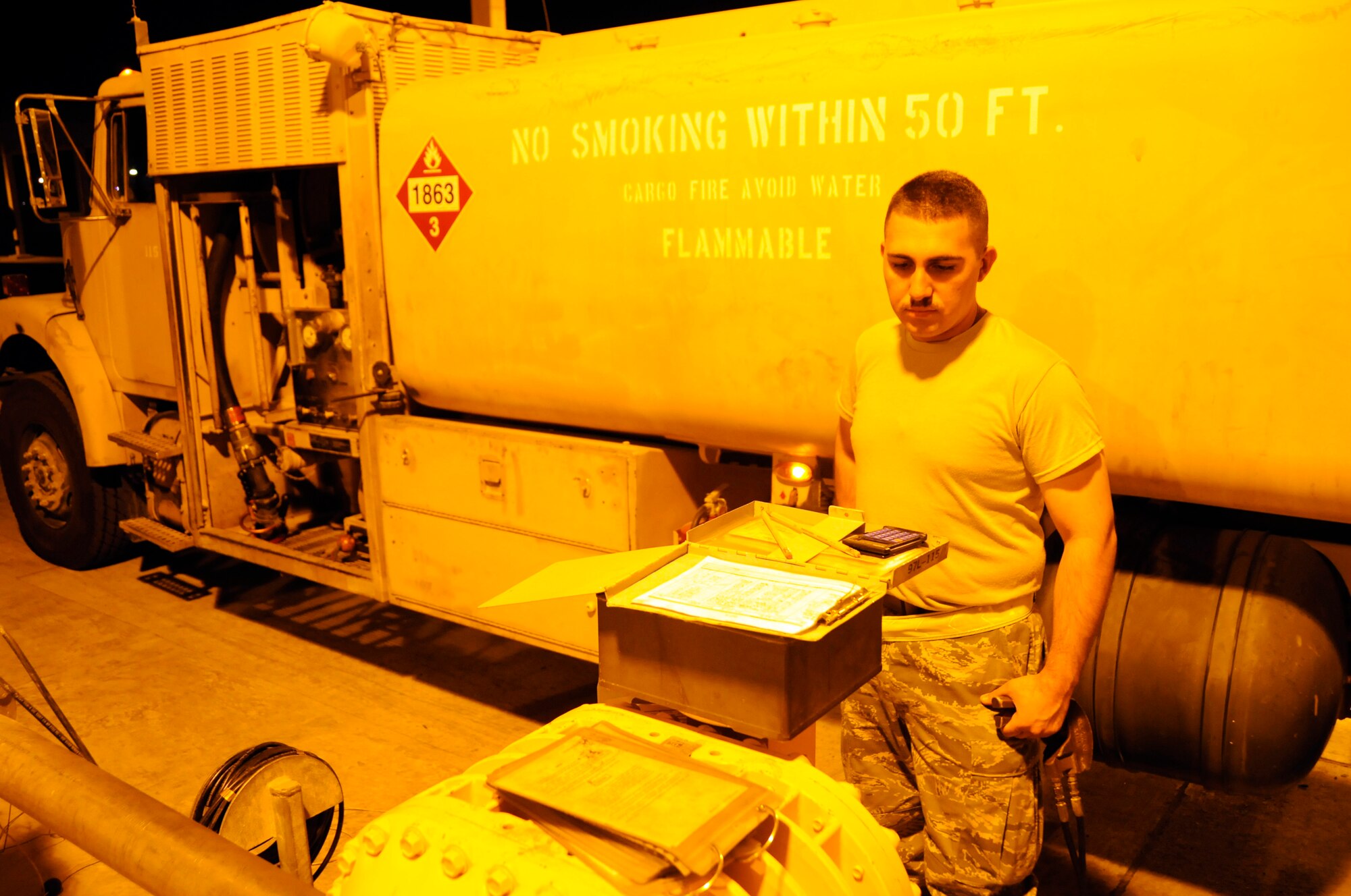 Airman 1st Class David McNabb, 379th Expeditionary Logistics Readiness Squadron, prepares to complete his paperwork as the gallons rush into his fuel truck October 7, 2008.  Working the night shift is in no way slow as Airman McNabb fills his truck for the first of many fill-ups tonight at an undisclosed air base in Southwest Asia.  The fuel truck drivers do their jobs night and day, keeping the jets fueled and ready to fly whenever the mission calls for them.  Airman McNabb, a native of Ontario, Calif., is deployed from Dover Air Force Base, Del., in support of Operations Iraqi and Enduring Freedom and Joint Task Force-Horn of Africa.  (U.S. Air Force photo by Tech. Sgt. Michael Boquette/Released)