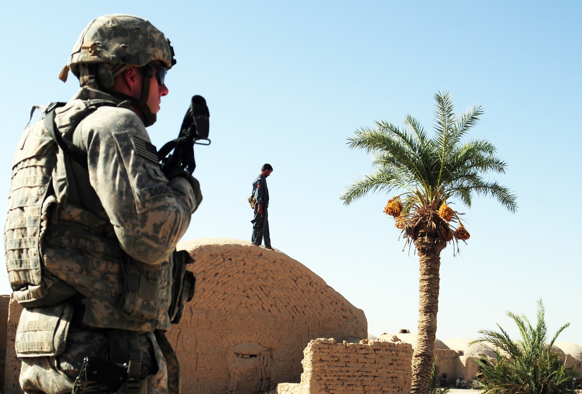 1st Lt. Edward Dudick, Pennsylvania Army National Guard, provides overwatch protection in the village of Khormelq during a shura meeting with village elders and Farah Provincial Governor Azadi Roohul Amin. The men and women of the Farah Provincial Reconstruction Team call one of America’s most remote military outposts home. More than 430,000 local people also call the vastness of this province home. Together, the people of Farah and the people of the PRT are working feverishly to make home life better for all in one of Afghanistan’s most austere regions. (U.S. Air Force photo by Lt. Col. Leslie Pratt)