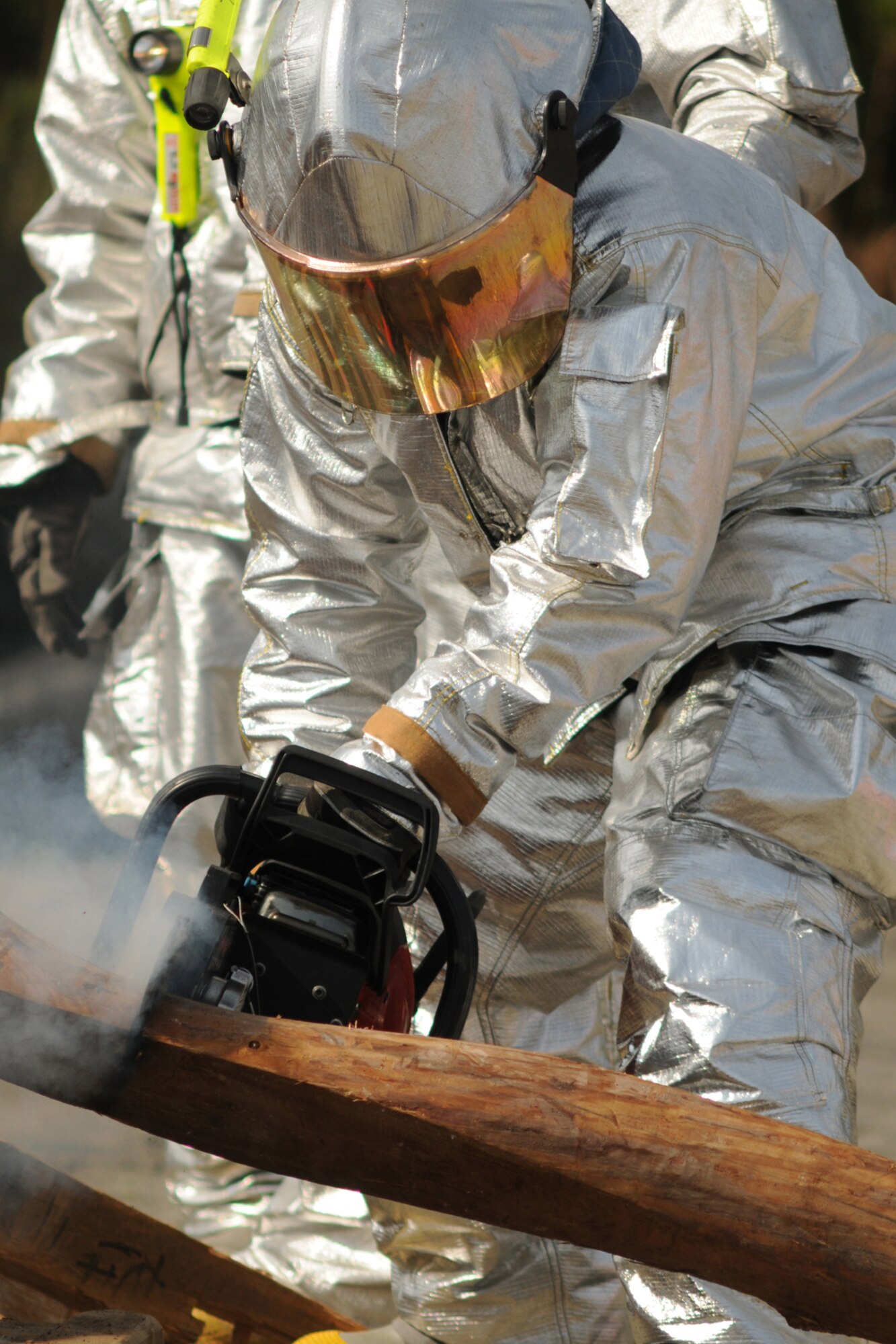 MISAWA AIR BASE, Japan -- Firemen and emergency responders with the Misawa Air Base's 35th Civil Engineer Squadron cut through a parts of a collapsed structure during a disaster preparedness exercise Oct. 5, 2008. After cutting, the teams were able to extract mock victims from the wreckage. (U.S. Air Force photo by Airman 1st Class Jamal Sutter)