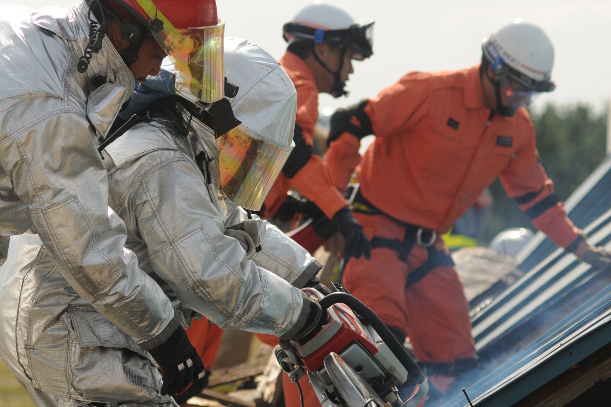 MISAWA AIR BASE, Japan -- Firemen and emergency responders with the Misawa Air Base's 35th Civil Engineer Squadron, Japan Self-Defense Force, and Misawa City rescue workers cut through a downed structure during a disaster preparedness exercise Oct. 5, 2008. Once finished cutting, the teams were able to remove mock victims from the debris. (U.S. Air Force photo by Airman 1st Class Jamal Sutter)