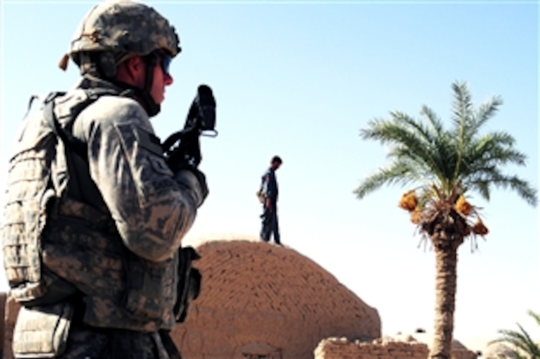 U.S. Army 1st Lt. Edward Dudick provides overwatch protection in the village of Khormelq, Afghanistan, during a shura meeting of village elders and Farah Provincial Governor Azadi Roohul Amin, Oct. 2, 2008. 