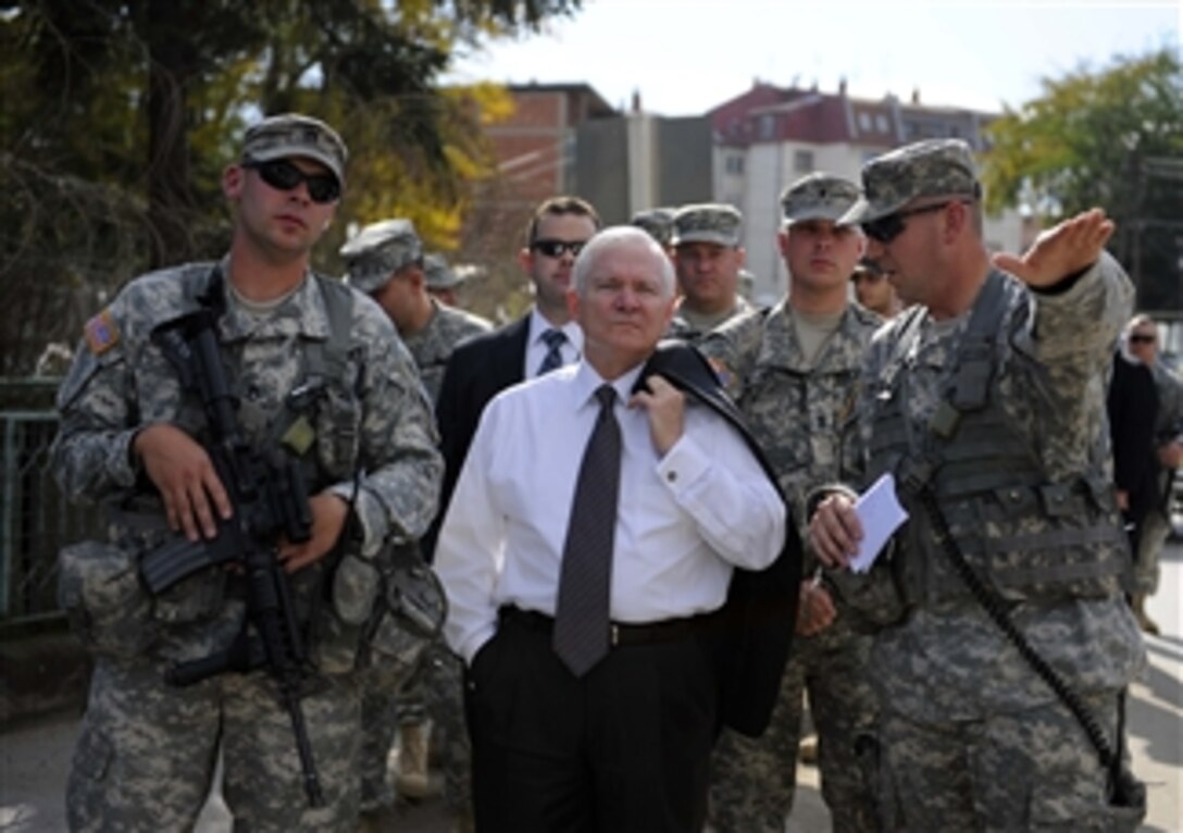 Secretary of Defense Robert M. Gates listens to a U.S. soldier during his tour of Gnjilane, Kosovo, with members of the liaison monitoring team on Oct. 7, 2008.  