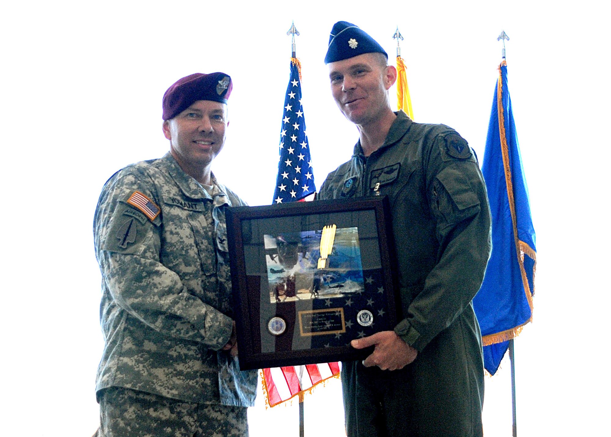 CANNON AIR FORCE BASE N.M.-- Army Col. Charles Yomant, Deputy Commander of the Special Operations Command Air Component presents a framed collage of different SOCOM assets Oct. 8 to Col. Paul Caltagirone, former 3rd Special Operations Squadron commander. The gift symbolizes Special Operations Forces appreciation to the 3rd SOS for its support.  (U.S. Air Force photo by Airman Maynelinne De La Cruz)