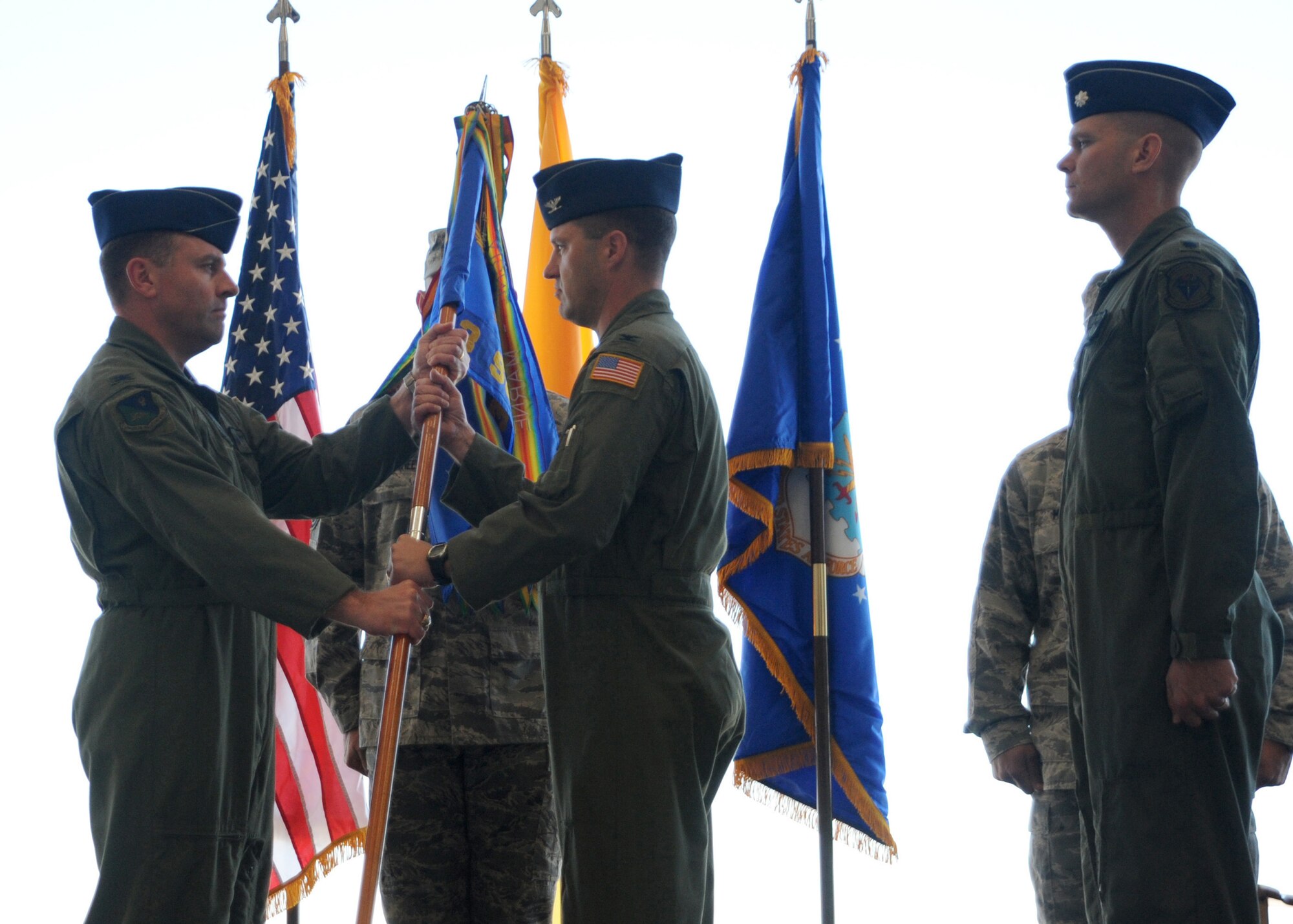 CANNON AIR FORCE BASE N.M.-- Col. Timothy Leahy, 27th Special Operations Wing commander, transfers the 3rd Special Operations Squadron guidon to Col. James Cardoso, 27th Special Operations group commander Oct. 8. Colonel Cardoso then transferred the guidon to Lt. Col. Paul Caltagirone, former 3rd SOS commander.  The guidon handover signified the official transfer of the 3rd SOS from Nellis Air Force Base, Nev. to Cannon. (U.S. Air Force photo by Airman Maynelinne De La Cruz)
