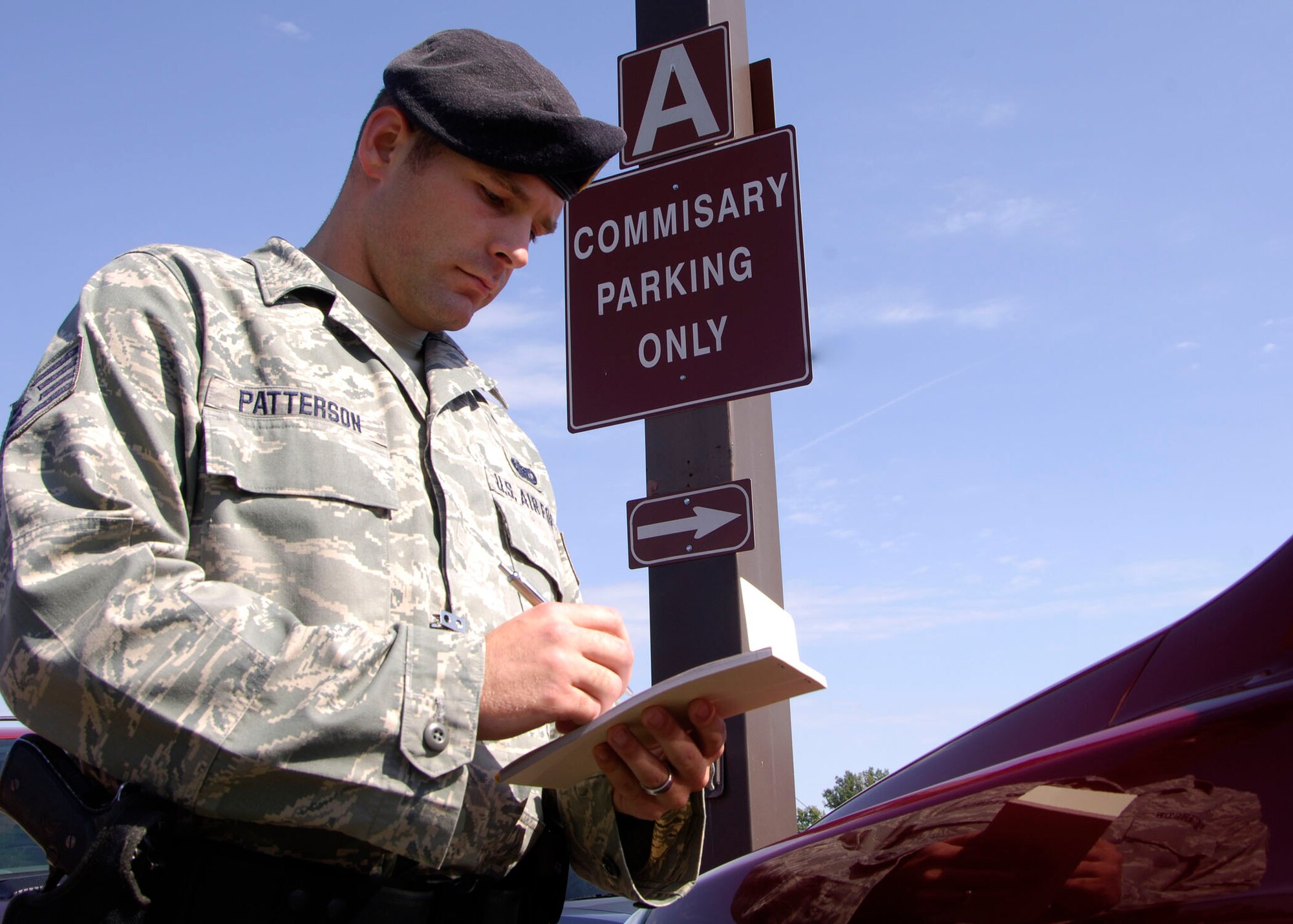 Staff Sgt. Steven Patterson, 375th Security Forces Squadron installation patrolman, writes a ticket for a car illegally parked in the Commissary/BX parking lot last week. Security Forces has begun actively patrolling these parking areas and issuing citations for those that are using the parking lots during the construction for U.S. Transportation Command.

(U.S. Air Force photo/AIrman 1st Class Wesley Farnsworth)