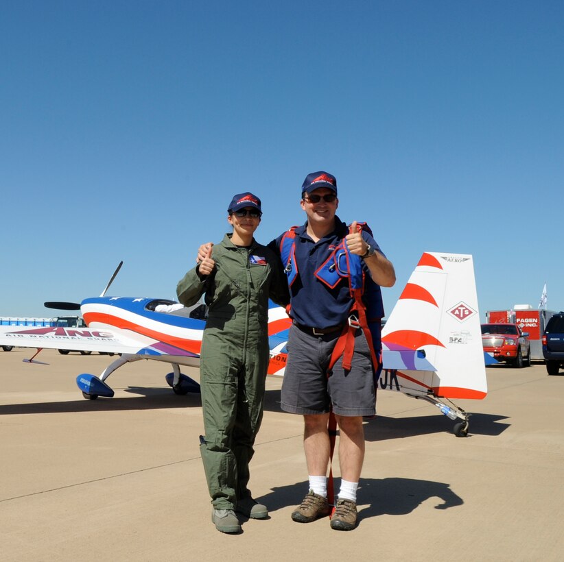 Air Force Tech Sgt Nora Castro, 136th Mission Support Flight, Texas Air National Guard, gives thumbs up after flying with John Klatt, stunt pilot for the Air National Guard over Alliance Airport as part of the Recruiting and Retention 2008 Air Show in North Texas. October 8, 2008 (USAF photo by Senior Master Sgt Elizabeth Gilbert)