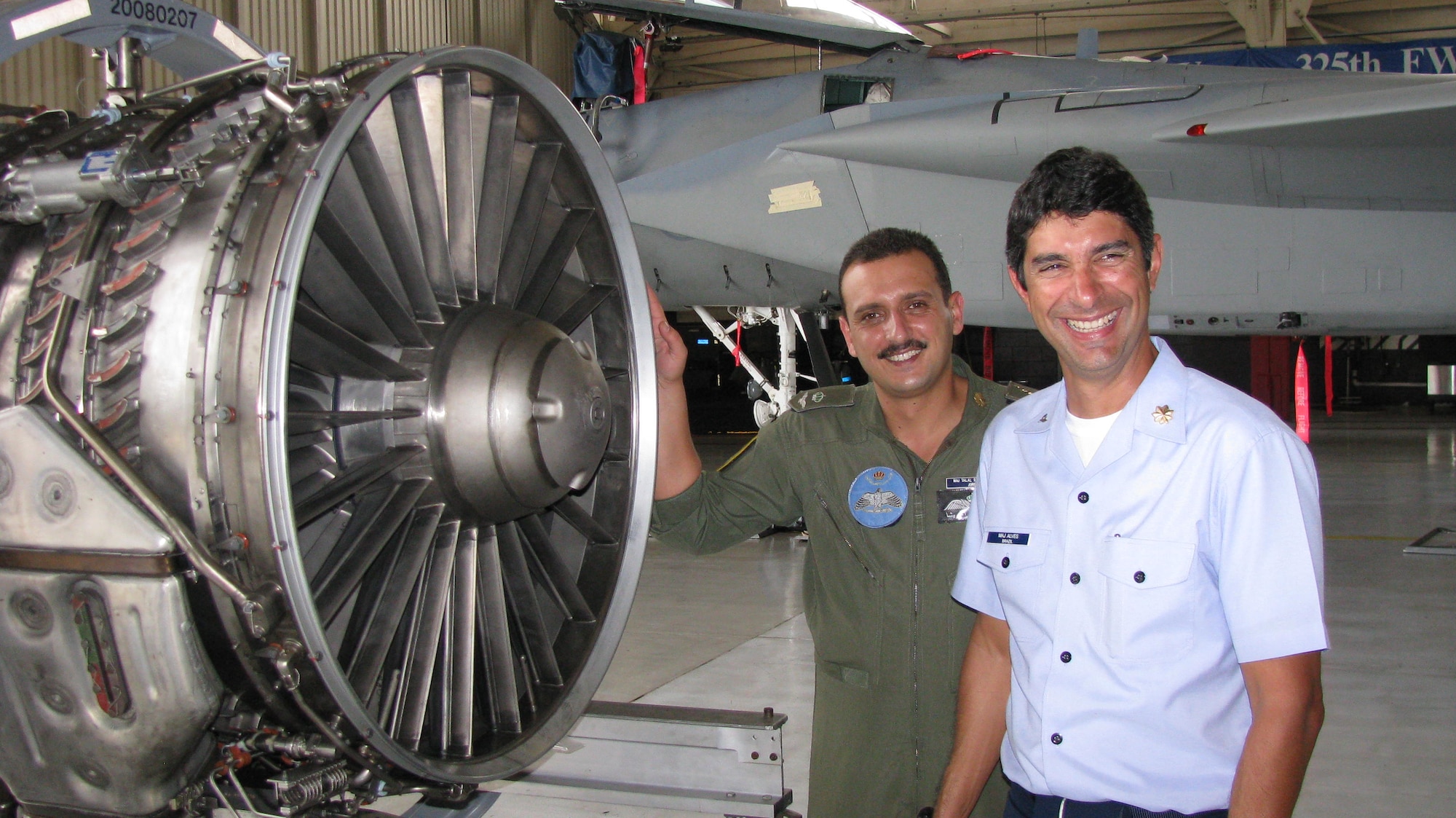 Maj. Talal Saleh Khraisha, a Jordanian Royal Air Forces Black Hawk pilot, and Maj. Robert Alves, a Brazilian Air Force transport pilot, examine a F-15C Pratt & Whitney F100 engine during a visit to Tyndall Air Force Base, Fla.  The two foreign officers visited the 325th Fighter Wing for U.S. Air Force safety training.  Tyndall is an ideal location for new safety officers to learn major safety disciplines- ground, flight and weapons safety. The officers are slated to become chief of safety for their respective countries when they return home. (U.S. Air Force photo by Mike Simons)