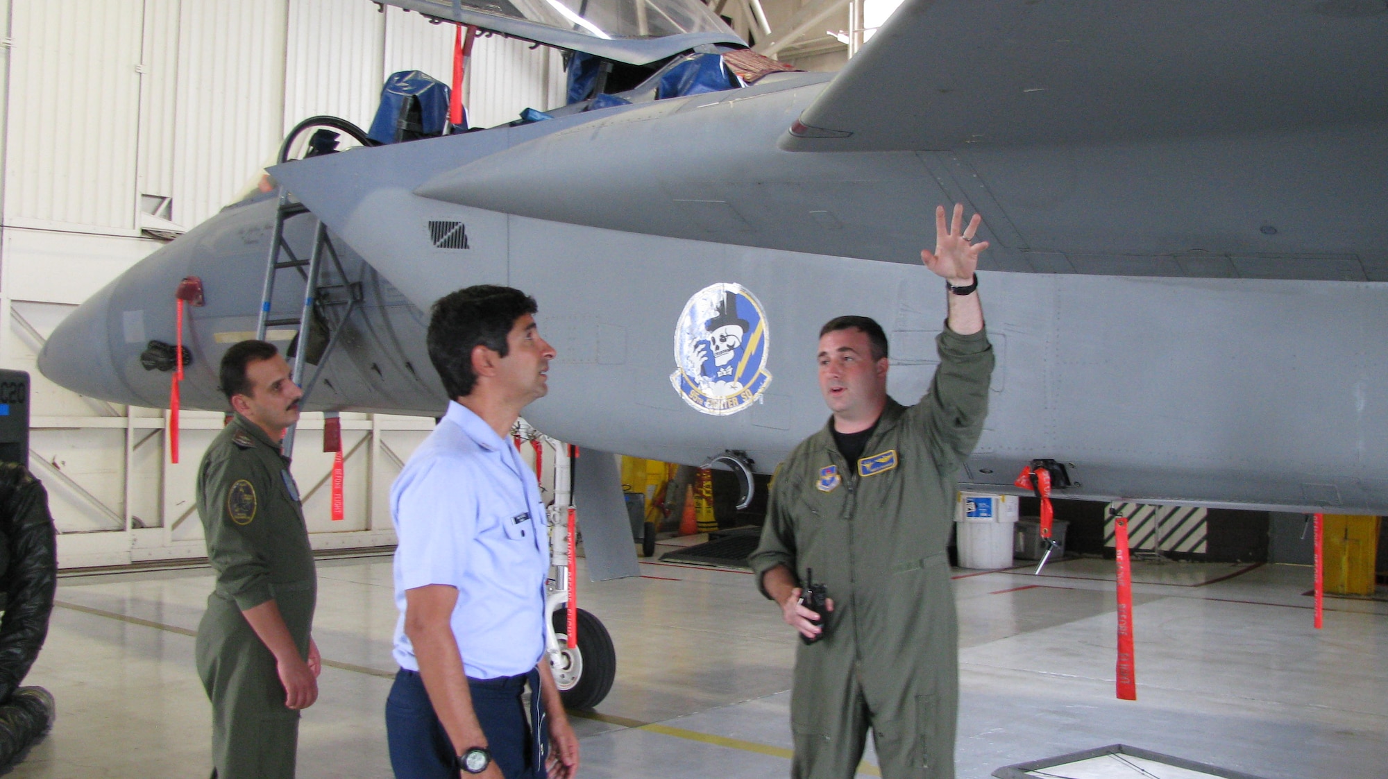 Maj. Talal Saleh Khraisha, a Jordanian Royal Air Forces Black Hawk pilot, and Maj. Roberto Alves, a Brazilian Air Force transport pilot, learn about the F-15C and air  superiority from Capt. Matthew Thomas, 95th  Fighter Squadron Flight Safety officer. The foreign officers toured the 325th Fighter Wing learning about Air Force safety. Major Khraisha and Major Alves were instructed on ground, flight and weapons safety during their Tyndall visit. (U.S. Air Force photo by Senior Master Sgt. Rich Street)