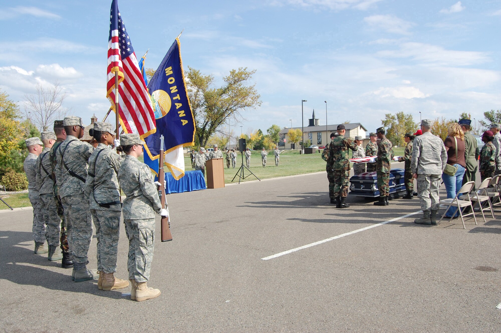 Members of the Honor Guard present the colors during the firing of the three vollies and playing of taps during a mock funeral at Medal of Honor Park Oct. 3. The mock funeral was held in conjunction with the graduation of 18 new Honor Guard members who went through a week of Honor Guard training. (U.S. Air Force photo/Senior Airman Emerald Ralston)