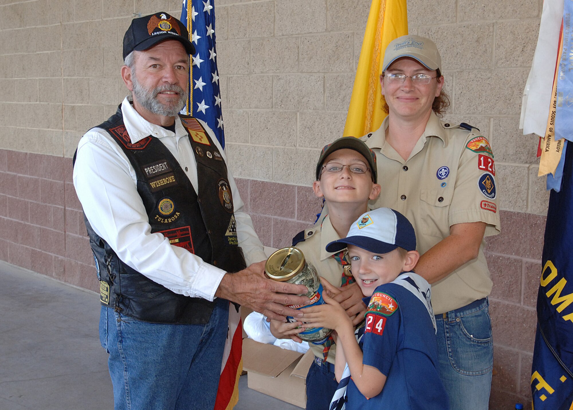 Mr. Ed Sumerall, American Legion Riders Chapter 8, Post 108 president, receives the donations collected by Cub Scout Pack 124, September 27, at Holloman Air Force Base, N.M.  (U.S. Air Force photo / Airman 1st Class John D. Strong II)