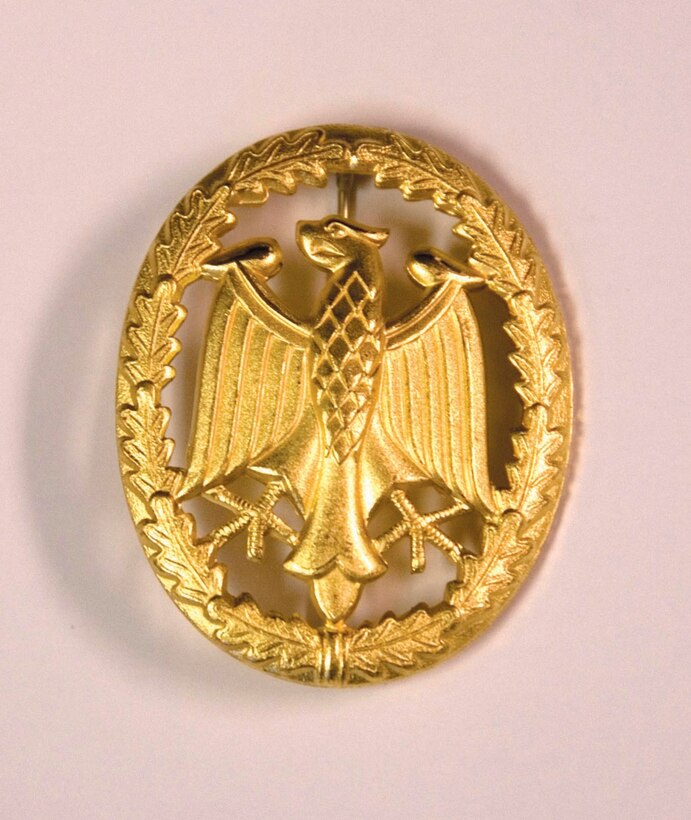 The gold German Armed Forces, Troop Duty Proficiency Badge was awarded to the 316th Security Forces Squadron Ravens after a 25K march.  The badge is worn 1/2 inch above and centered on the Airman’s nametag. .   (USAF photo by Tech. Sgt. Adrianne M. Wilson)