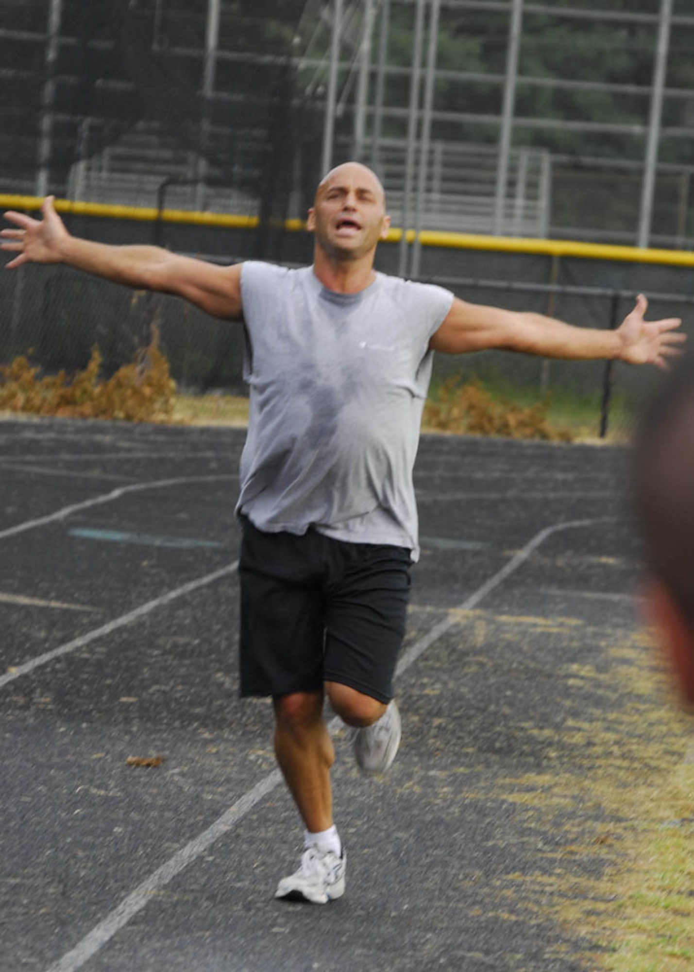 Army Master Sgt. Aaron Jesko of the National Guard Bureau, celebrates as he reaches the finish line during the 1.85 mile run Aug. 27, while trying to obtain the German Armed Forces, Troop Duty Proficiency Badge.   (USAF photo by Tech. Sgt. Adrianne M. Wilson)