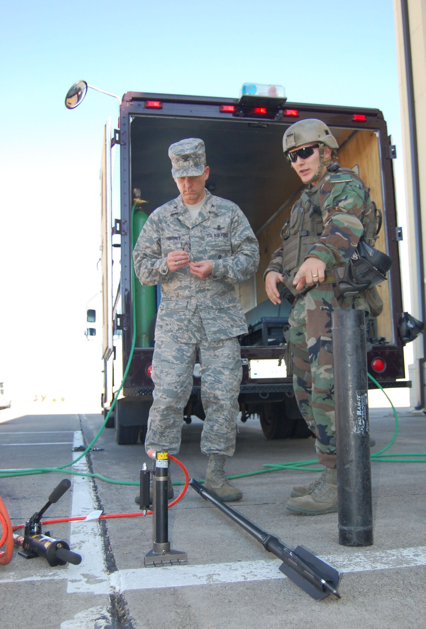 Senior Airman Jeremy Thatcher, 341st Security Forces Group Tactical Response Force member, explains the “rabbit tool” to Col. Michael Fortney, 341st Missile Wing commander, at the base’s new close-quarters battle center Sept. 30. The colonel received a tour of the new training facility, got a first-hand look of TRF’s equipment, and geared up and went through the course with a TRF team to apprehend a simulated “attacker.” 341st SFG personnel volunteered hundreds of hours to plan and construct the training facility.   (U.S. Air Force photo/Senior Airman Eydie Sakura)