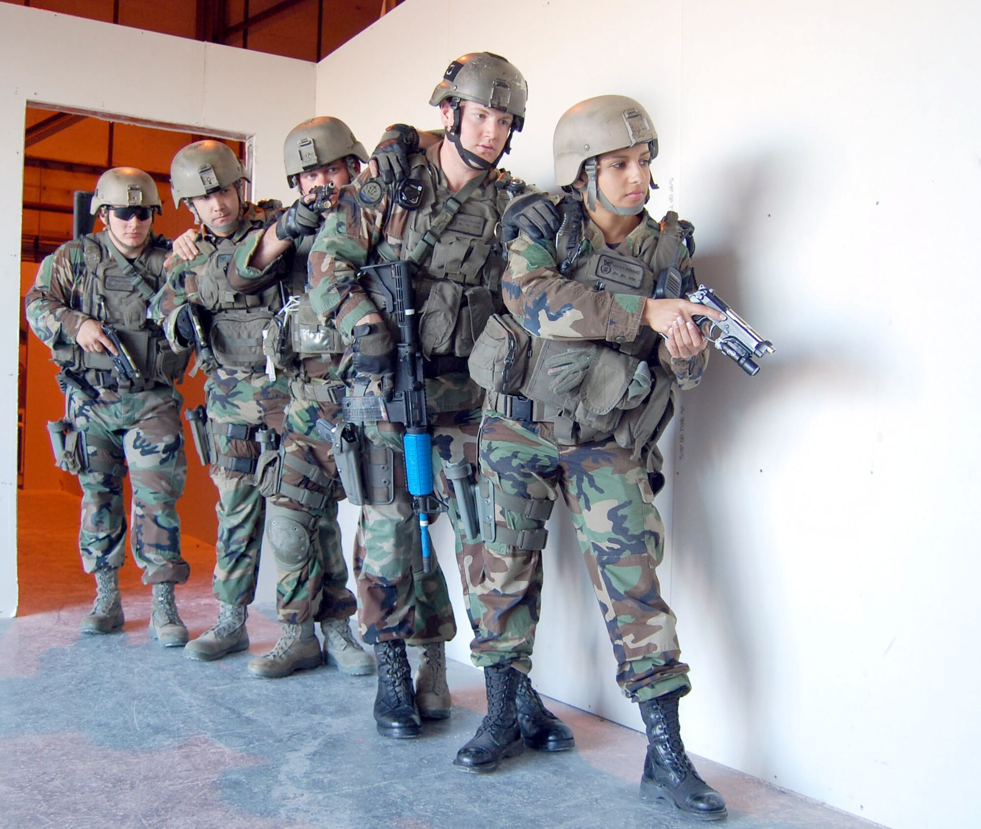 Members of the 341st Security Forces Group Tactical Response Force stack up outside the new close-quarters battle center prior to gaining entry and clearing the scene Sept. 30 during a training scenario. 341st SFG personnel volunteered hundreds of hours to plan and construct the training facility.  Team members include (right to left) Senior Airmen Liseth Rodriguez and Samuel Fullerton, Staff Sgts. David Barger and Derik Morris, and Senior Airman Jeremy Thatcher.  (U.S. Air Force photo/Senior Airman Eydie Sakura)