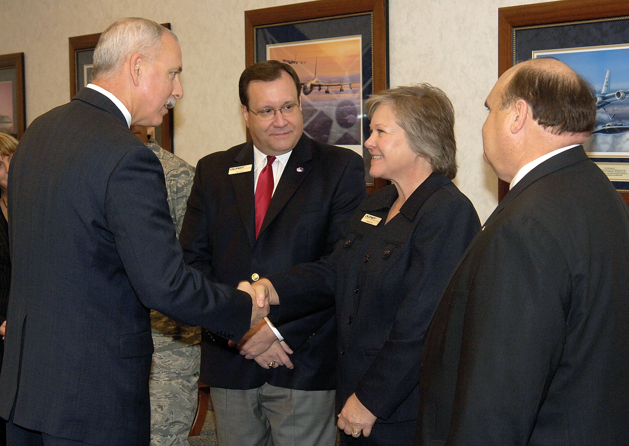 John Over, executive director of Tinker’s Oklahoma City Air Logistics Center, left, greets members of the Oklahoma Center for the Advancement of Science and Technology Tuesday in Bldg. 3001.  Mr. Over and OCAST executive director Michael Carolina signed a memorandum of understanding aimed at furthering cooperative research and development between the two entities.  Pictured with Mr. Over are OCAST members, from left; Dan Luton, Debbie Cox and Steve Paris.   (Air Force photo/Margo Wright)