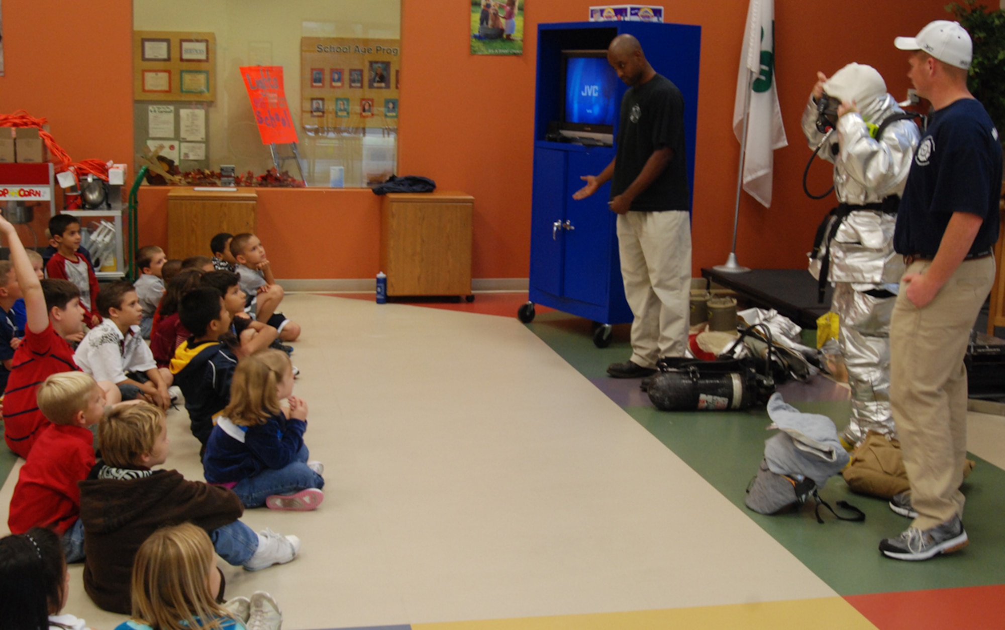 MCCONNELL AIR FORCE BASE, Kan. -- McConnell firemen teach youths at the School Age Program to have a family fire escape plan, monitor home smoke detectors and identify suited firemen as being safe people to seek out during an emergency, Oct 6. (Photo by Airman 1st Class Jessica Lockoski)