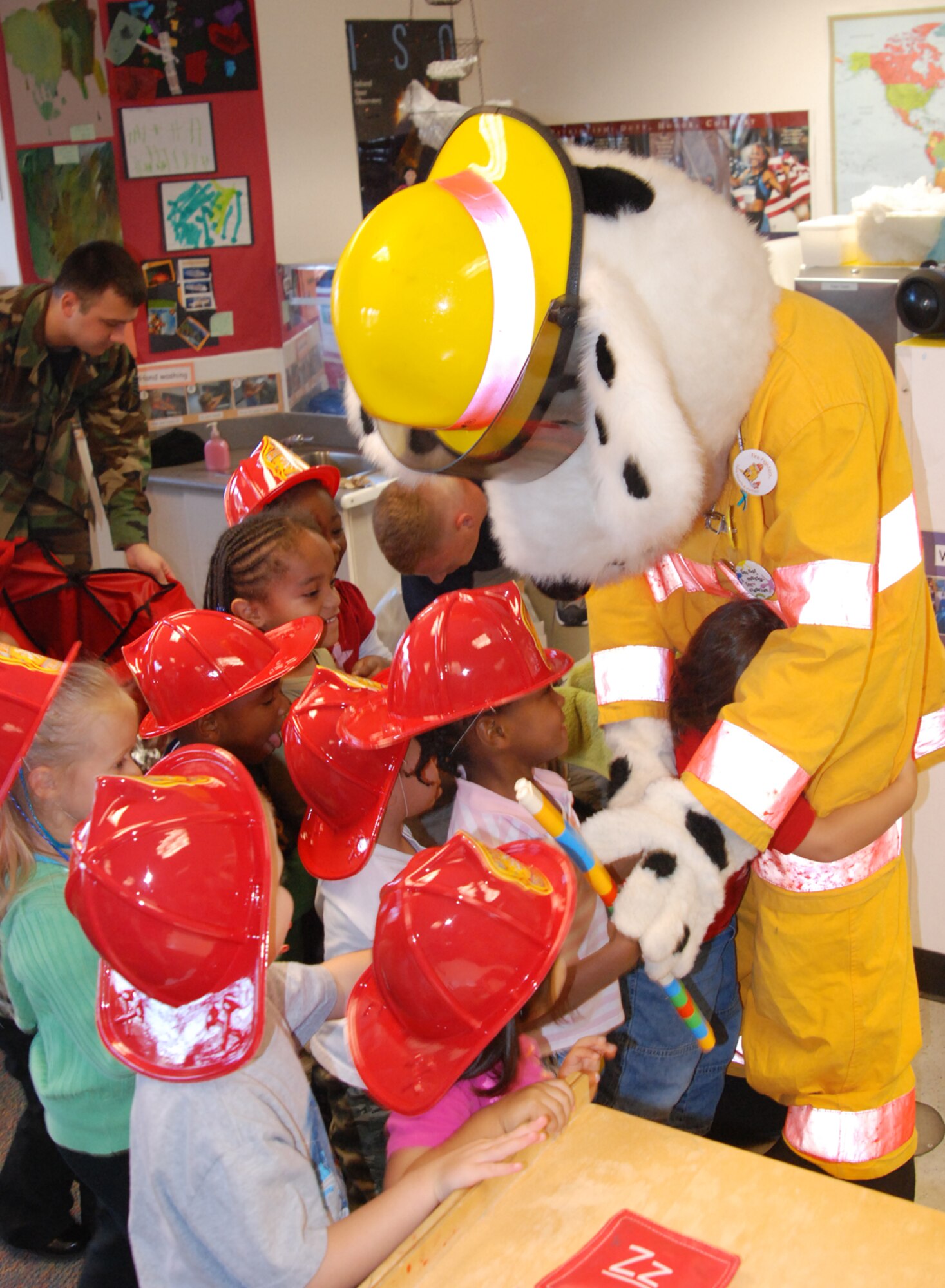 MCCONNELL AIR FORCE BASE, Kan. -- Sparky, the firedog, and members from the base fire department, visit McConnell youths at the Child Development Center, Oct. 8, during Fire Prevention Week. (Photo by Airman 1st Class Jessica Lockoski)  
