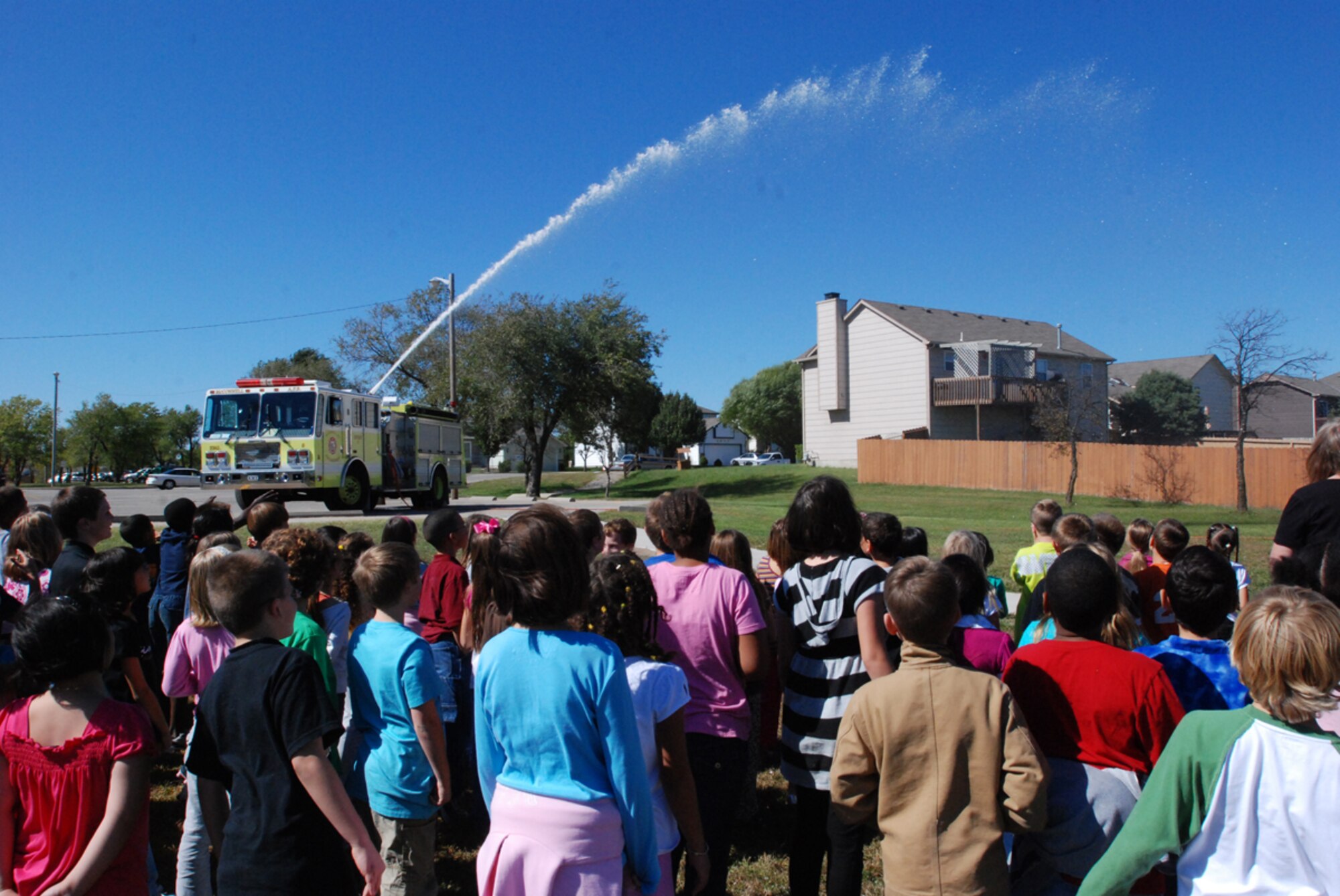 MCCONNELL AIR FORCE BASE, Kan. -- The McConnell fire department visits Wineteer Elementary School Students in Wichita, Kan. throughout Fire Prevention Week, October 5-11, to educate youths about fire safety and demonstrate how the water apparatus on their truck helps battle fires. (Photo by Airman 1st Class Jessica Lockoski)  