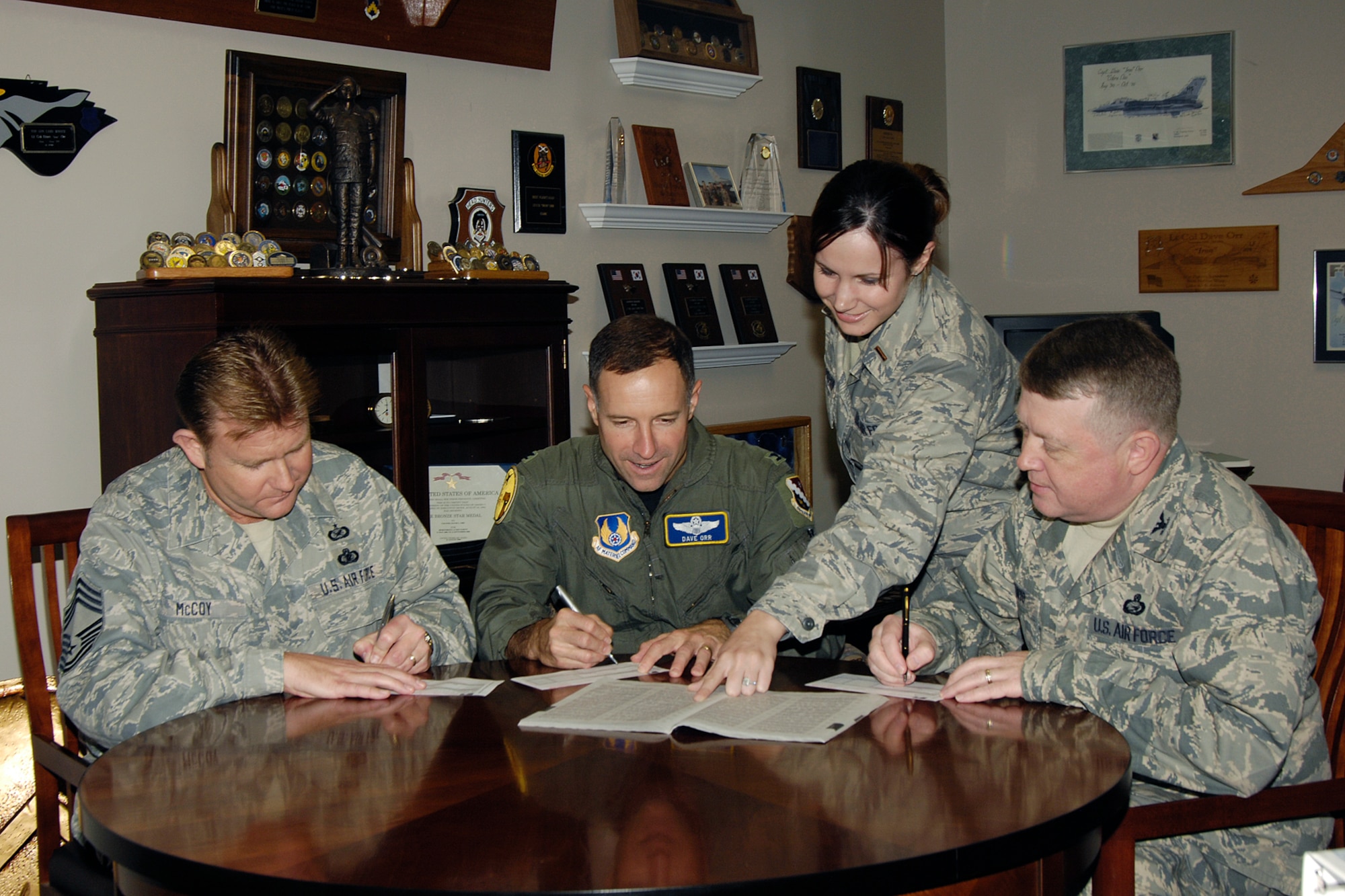 HANSCOM AFB, Mass. – 66th Air Base Wing leaders, seated from left, Chief Master Sgt. Michael McCoy, 66th Mission Support Group superintendent, Col. David Orr, 66 ABW commander and Col. Jeffrey Mayo, 66 ABW vice commander, fill out their Combined Federal Campaign contribution forms on Oct. 2 with the assistance of 2nd Lt. Holly Chernushin, 66 ABW Combined Federal Campaign representative.  Hanscom’s CFC began Oct. 1 and will run until Nov. 14 with a goal of raising $237,000. (U.S. Air Force photo by Linda LaBonte Britt)