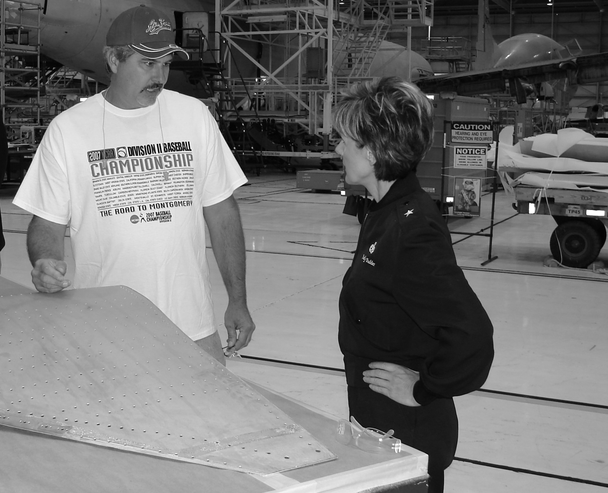 Bryan Chandler, 566th Aircraft Maintenance Squadron, shows 76th Maintenance Wing commander, Brig. Gen. Judith Fedder, a zero skin on an E-6 aircraft. Mr. Chandler won $10,000 for his idea of removing the zero skins as a whole assembly and saving the Air Force from ordering new skins. (Air Force photo)