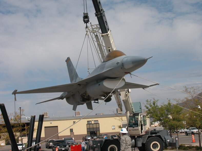 The F-16 that once welcomed visitors to the former 419th Fighter Wing headquarters building is crane-lifted to the ground Oct. 2. The aircraft’s landing gear was reassembled before being moved across base, where it will be restored over the course of several months, and relocated closer to the new 419th and 388th Fighter Wings’ headquarters. (U.S. Air Force photo/Bryan Magaña)
