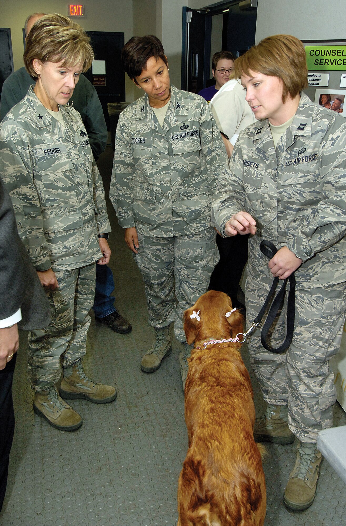 Capt. Susan Sheets, right, tells about Georgia her foster dog and the rescue organization they represent during the CFC Agency Fair Oct. 2 in Bldg. 3001. Brig. Gen. Judith Fedder, left, 76th Maintenance Wing commander, and Col. Mona Lisa Tucker, 72nd Air Base Wing vice commander, were among many who visited the sixteen organizational booths representing a fraction of the groups seeking Tinker’s support during the annual fund raising campaign.  (Air Force photo/Margo Wright)