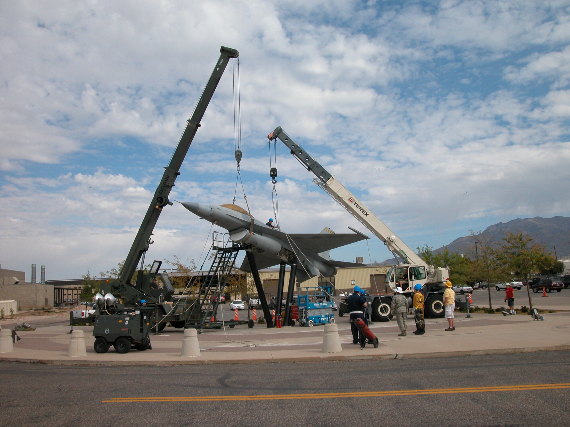 419th Fighter Wing personnel help remove an F-16 static display from its pedestals Oct. 2. The aircraft, which graced the former wing headquarters building, will be restored over the course of several months and moved to its new location closer to the new 419th and 388th Fighter Wings headquarters. (U.S. Air Force photo/Bryan Magaña)