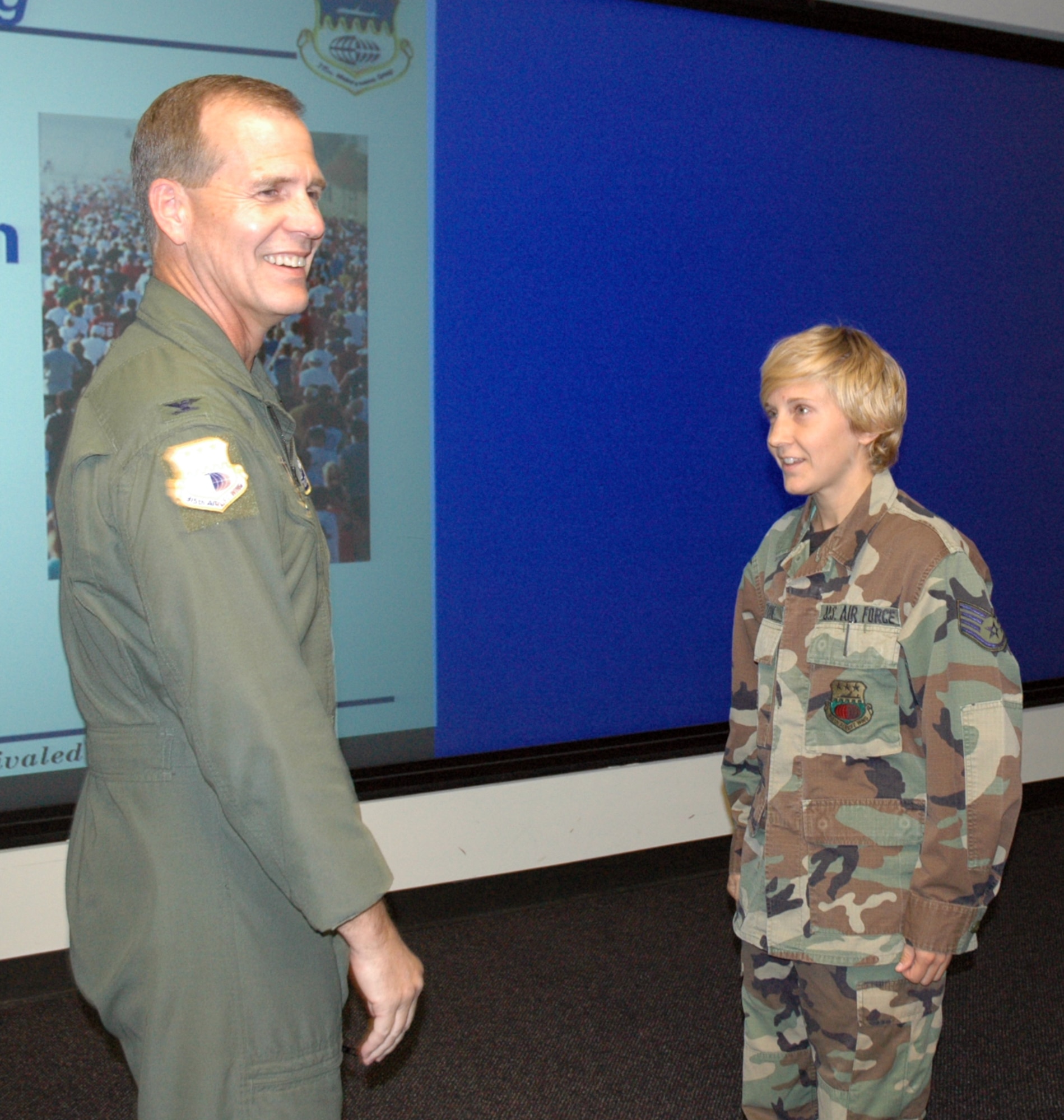 315th Airlift Wing Commander Colonel Timothy Wrighton congratulates Staff Sergeant Hannah Paxton of the 81st Aerial Port Squadron on her second place finish at the 2008 Air Force Marathon among all military females.   (U.S. Air Force photo/Tech. Sgt. Jeff Kelly) 