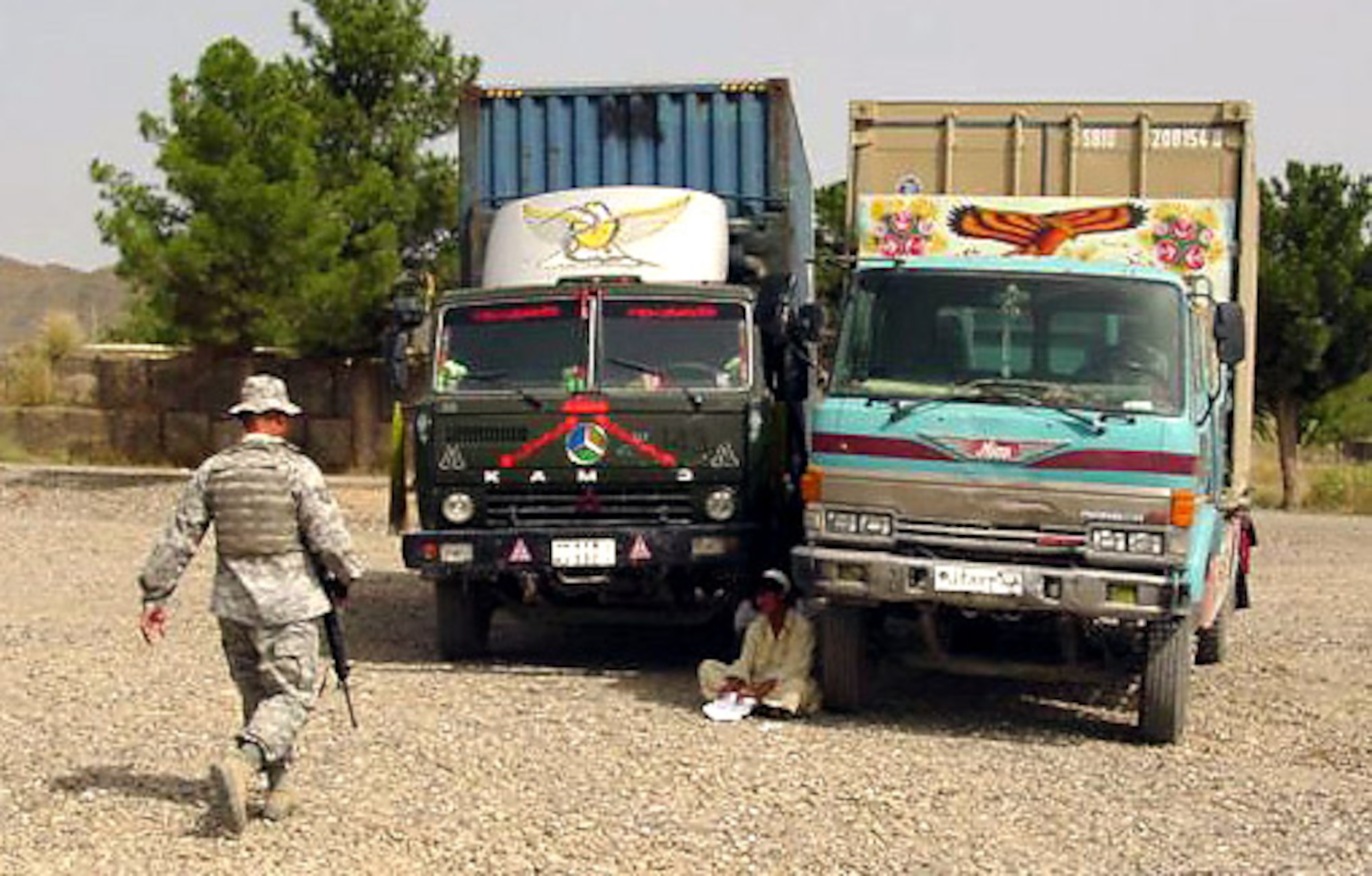 Staff Sgt. Arnoldo Vazquez approaches a local truck driver awaiting clearance into the cargo yard at Forward Operating Base Salerno, Afganistan. Sergeant Vazquez is responsible for clearing all supply drivers and their "jingle trucks" for entry into the FOB. Sergeant Vazquez is deployed from Eielson Air Force Base, Alaska, and is a member of the surface military cargo team. (U.S. Air Force photo)