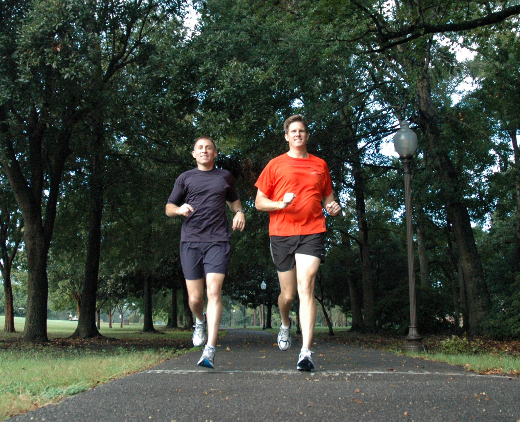 Master Sergeant Michael Bunting, 315th Airlift Wing Aircraft Maintenance Squadron and Lieutenant Colonel Patrick Maes, 437th Airlift Wing Inspector General cross the start/finish line at McCombs Way, a running path on Charleston Air Force Base.  Both men participated in the 2008 Air Force Marathon and Master Sgt. Bunting finished third among all male military runners. (U.S. Air Force photo/Tech. Sgt. Jeff Kelly) 
