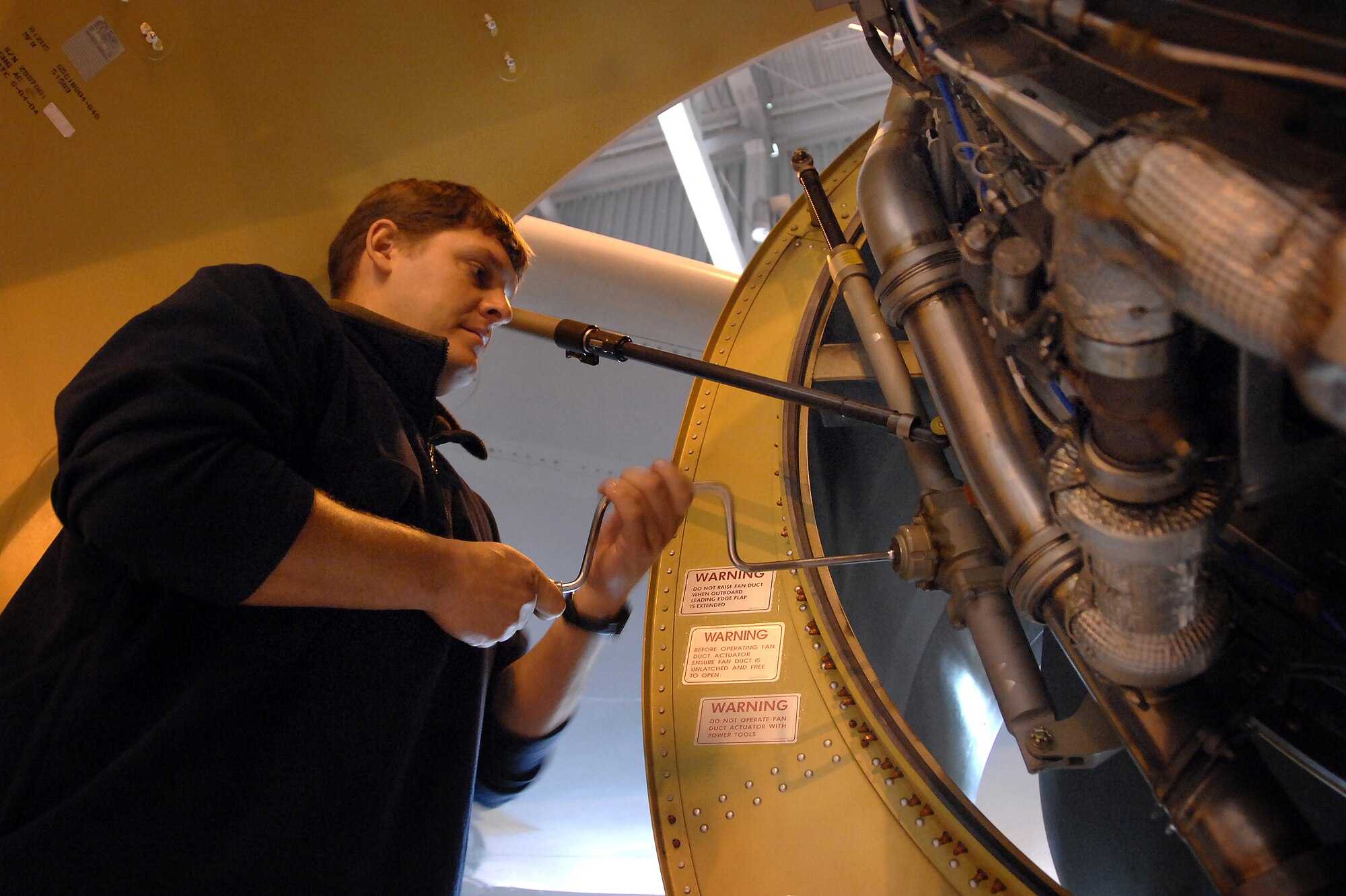 OFFUTT AIR FORCE BASE, Neb. -- Travis Hunsicker, an aircraft technician with the 55th Maintenance Squadron, closes the F108 Engine Fan Duct on a TC-135W pilot training aircraft in Dock 1 of the Bennie Davis Maintenance Facility here, Oct. 1. (U.S. Air Force Photo By Josh Plueger)