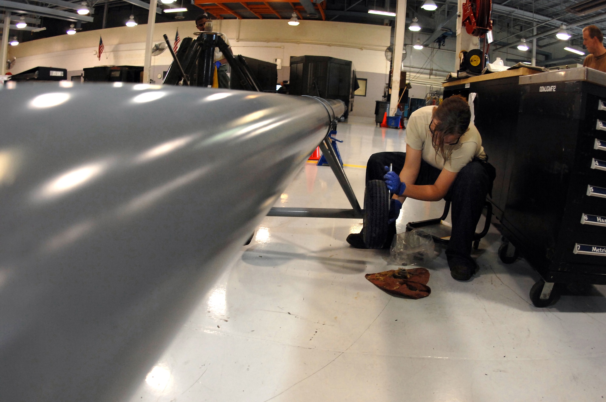 OFFUTT AIR FORCE BASE, Neb. -- Senior Airman Jacqueline Weekly, an aerospace ground equipment mechanic assigned to the 55th Maintenance Squadron, repacks wheel bearings on an RC-135 tow bar here, Oct. 1. (U.S. Air Force Photo By Josh Plueger)