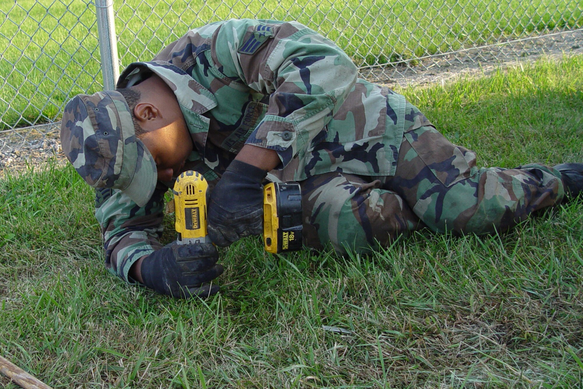 GRISSOM AIR RESERVE BASE, Ind., -- Senior Airman David Robinson-Johnson, an heating, ventillation and air conditioning apprentice with the 434th Civil Engineers Squadron, sets an anchor point for an exercise station beign constructed along the base running path. CE members have been working to install the stations along the course to help enhance physical fitness. (U.S. Air Force photo/Senior Master Sgt. Chuck Gill)