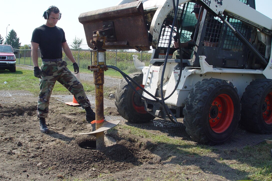GRISSOM AIR RESERVE BASE, Ind., -- Staff Sgt. Adam Loos, left, watches as Staff Sgt. David Motycka, drills a hole to set an exercise station along the running track on the base. Both are assigned to the 434th Civil Engineers Squadron. (U.S. Air Force photo/Senior Master Sgt. Chuck Gill)