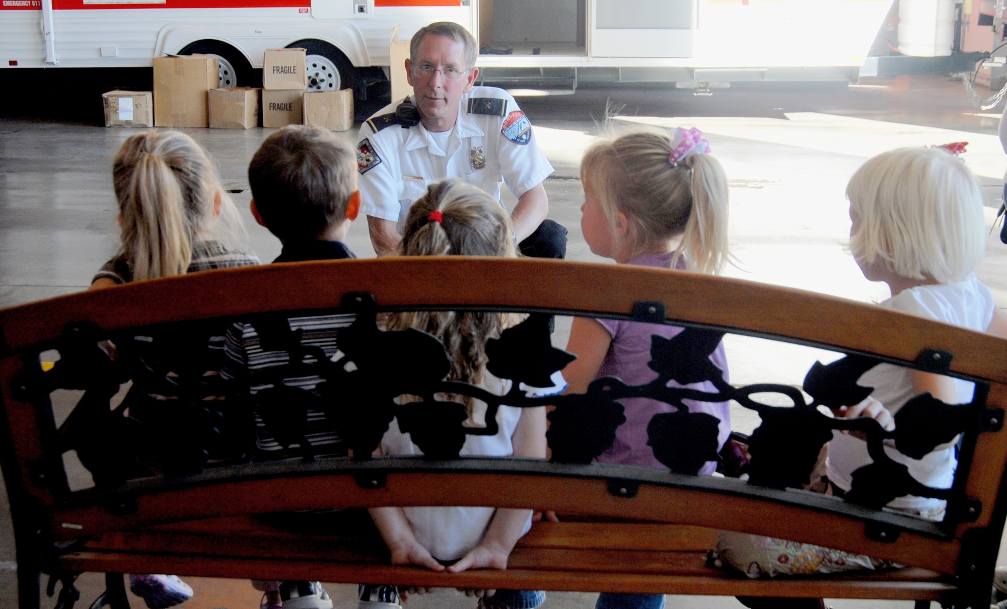 Kurt Stranick, fire department investigator, talks to Edwards children regarding fire safety Oct. 9 as part of Fire Prevention Week. Throughout the week, firefighters, Smokey the Bear and Sparky the Fire Dog visited base school, the Child Development Center and other locations to inform Team Edwards about fire safety. (Air Force photo by Senior Airman Julius Delos Reyes)