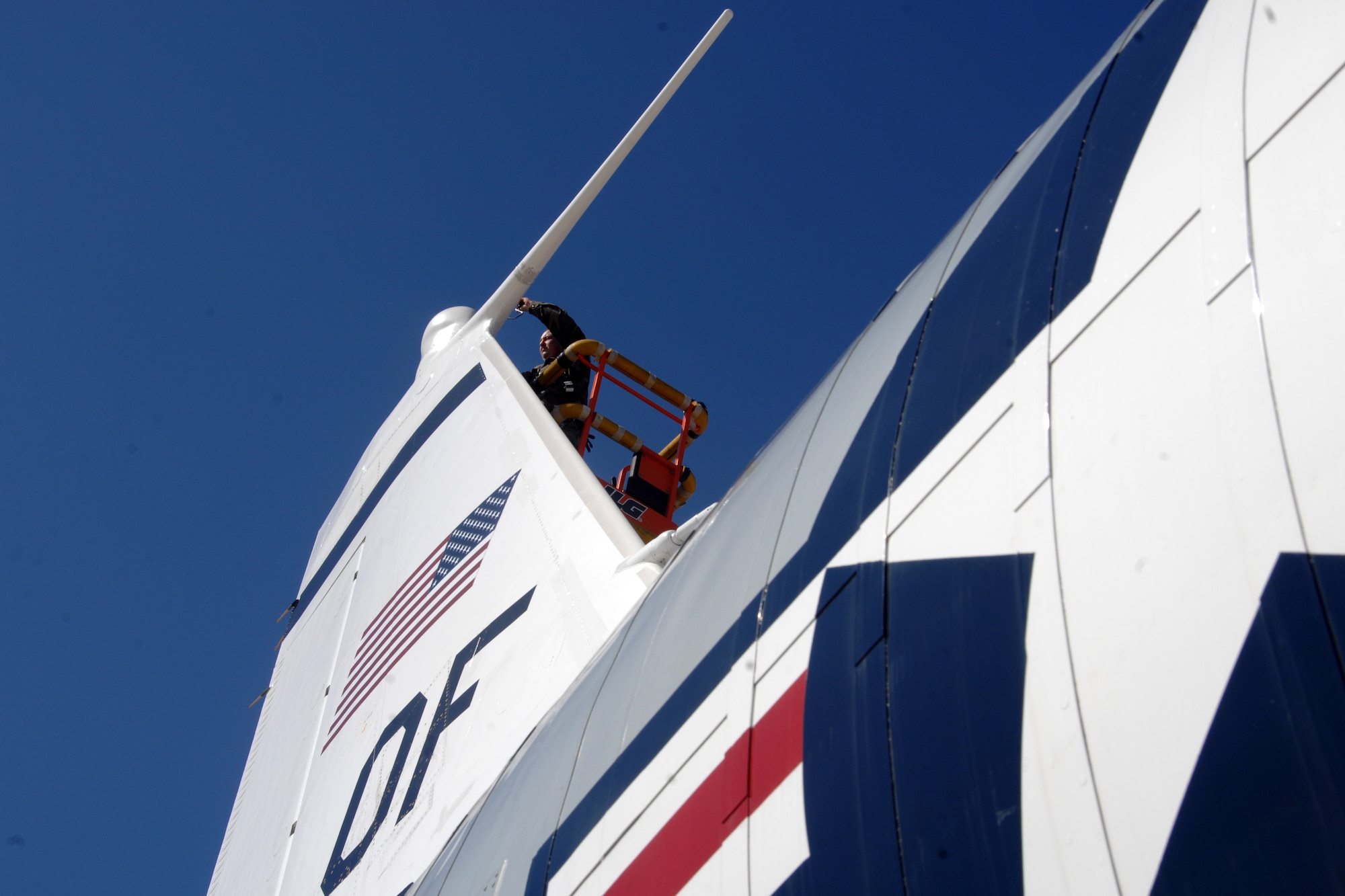 OFFUTT AIR FORCE BASE, Neb. -- Staff Sgt. Steven Pearson, a communication navigation mission systems craftsman with the 45th Aircraft Maintenance Unit, repairs a  high frequency coupler located on the tail of a RC-135U Combat Sent aircraft, located on a parking ramp here, Oct. 2. (U.S. Air Force Photo By Josh Plueger)