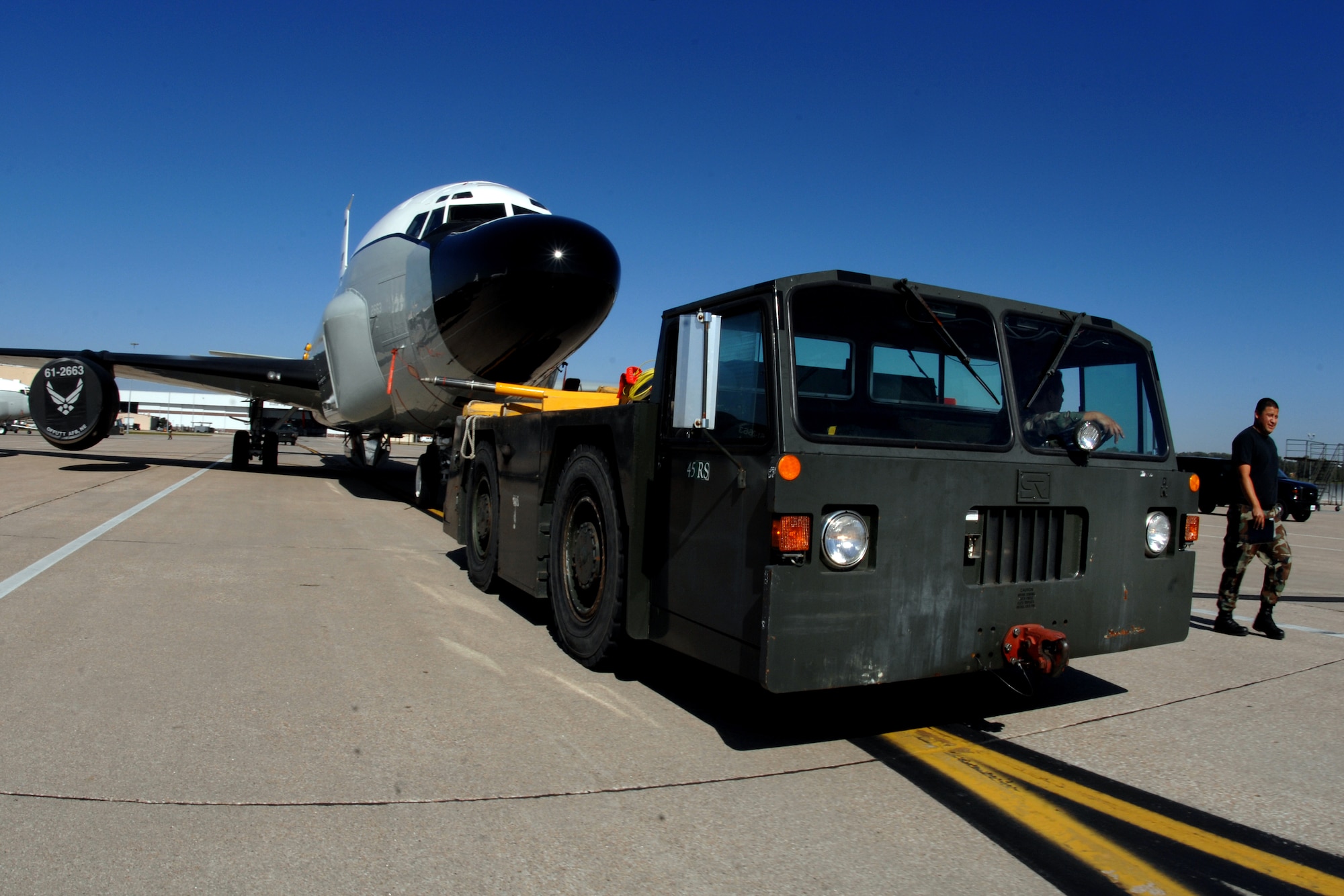 OFFUTT AIR FORCE BASE, Neb. -- A maintainer with the 55th Aircraft Maintenance Squadron, drives a T-400 UKE tow vehicle while pulling an RC-135 Cobra Ball airborne intelligence aircraft into position on the parking ramp here, after it was removed from an aircraft hangar, Oct. 2. (U.S. Air Force Photo By Josh Plueger)