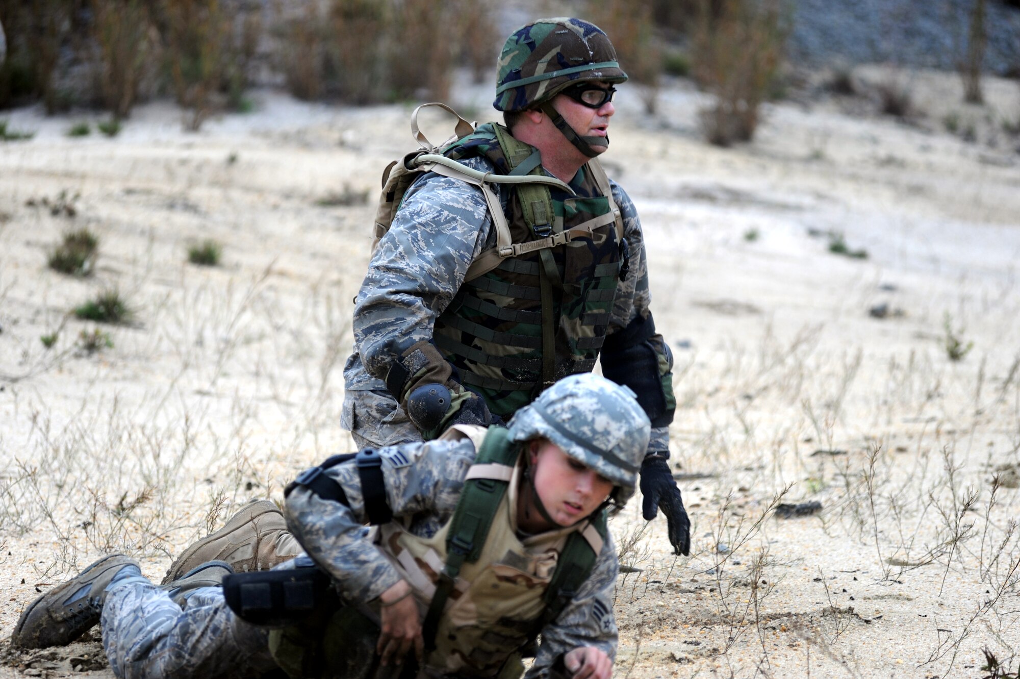 Students partcipating in functional-specific training for the Air Force legal career field learn "low-crawl" techniques during a class on a Fort Dix, N.J., range Oct. 1, 2008.  The functional-specific training for the students of the Air Force legal career field focuses on contingency skills basics, rules of use of force, rules of engagement and expeditionary basics for legal Airmen on deployment. The training is held for three days prior to them attending the Advanced Contingency Skills Training Course taught by the U.S. Air Force Expeditionary Center's 421st Combat Training Squadron on Fort Dix.  (U.S. Air Force Photo/Staff Sgt. Nathan Bevier)