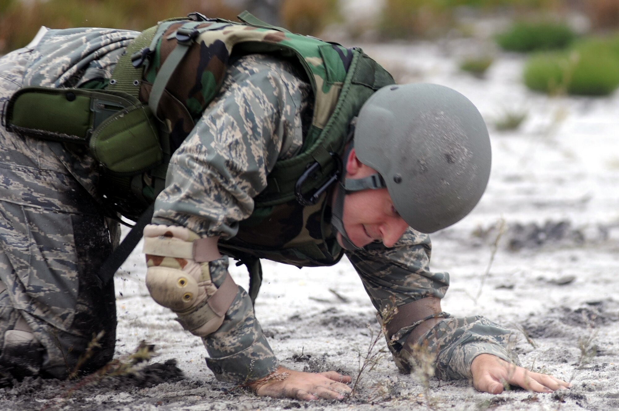 Capt. Justin Swick, from the 27th Special Operations Wing at Cannon Air Force Base, N.M., is among students partcipating in functional-specific training for the Air Force legal career field learning "low-crawl" techniques during a class on a Fort Dix, N.J., range Oct. 1, 2008.  The functional-specific training for the students of the Air Force legal career field focuses on contingency skills basics, rules of use of force, rules of engagement and expeditionary basics for legal Airmen on deployment. The training is held for three days prior to them attending the Advanced Contingency Skills Training Course taught by the U.S. Air Force Expeditionary Center's 421st Combat Training Squadron on Fort Dix.  (U.S. Air Force Photo/Staff Sgt. Nathan Bevier)