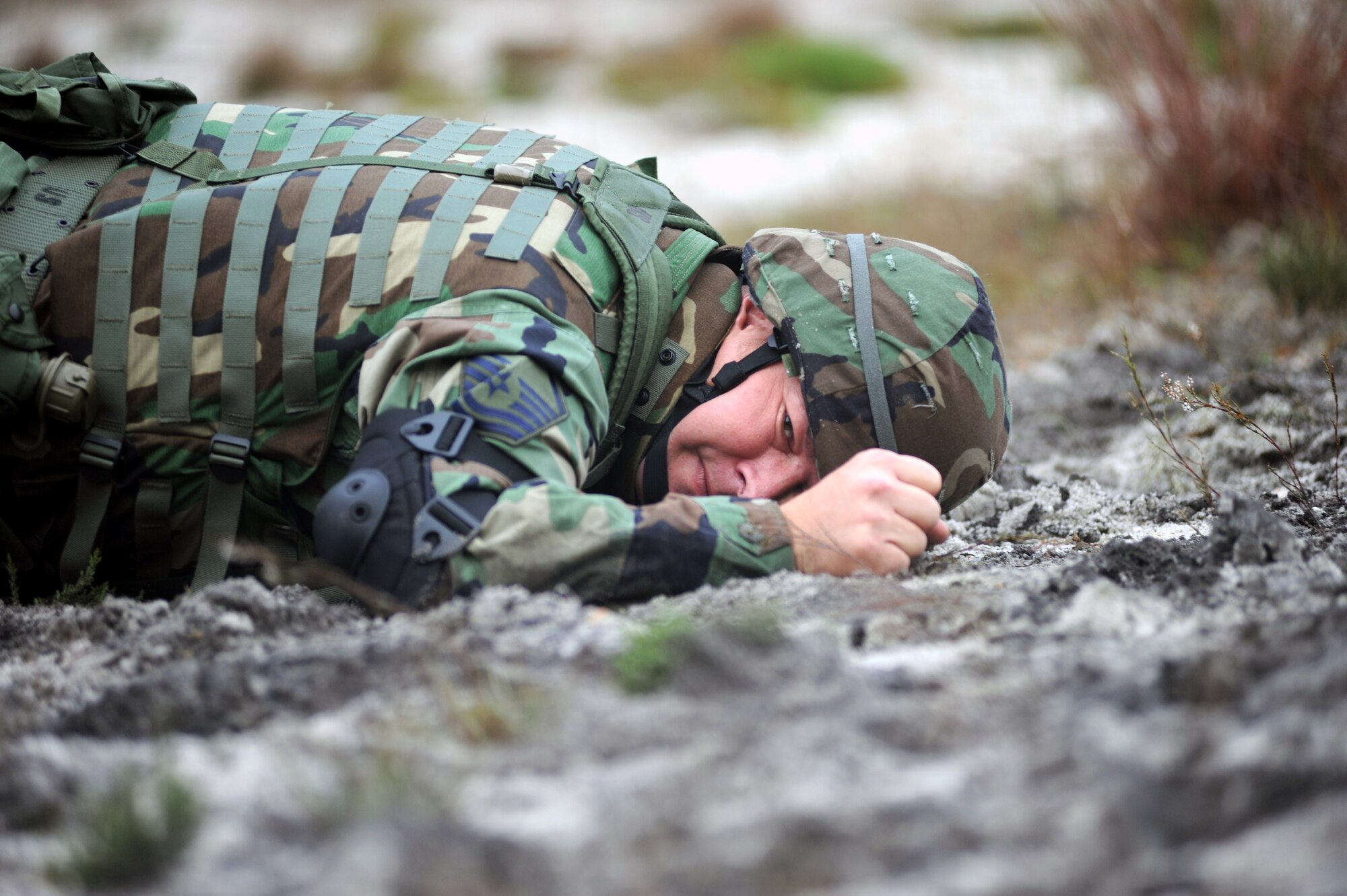 Master Sgt. Jeff Julig, from the Air Force Legal Operations Agency at the Pentagon, is one of several students partcipating in functional-specific training for the Air Force legal career field learning "low-crawl" techniques during a class on a Fort Dix, N.J., range Oct. 1, 2008.  The functional-specific training for the students of the Air Force legal career field focuses on contingency skills basics, rules of use of force, rules of engagement and expeditionary basics for legal Airmen on deployment. The training is held for three days prior to them attending the Advanced Contingency Skills Training Course taught by the U.S. Air Force Expeditionary Center's 421st Combat Training Squadron on Fort Dix.  (U.S. Air Force Photo/Staff Sgt. Nathan Bevier)