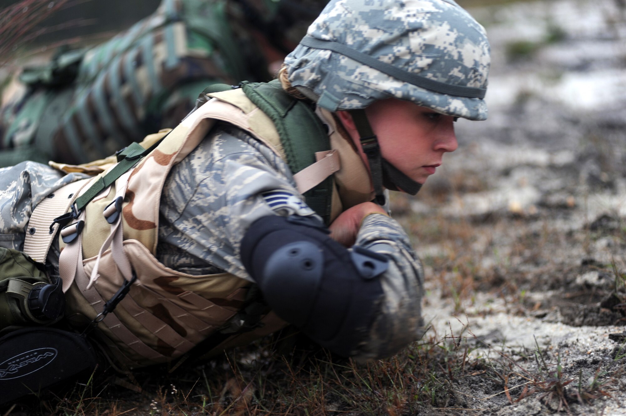 Senior Airman Jamie Palmiter, from the 314th Airlift Wing legal office at Little Rock Air Force Base, Ark., is with other students partcipating in functional-specific training for the Air Force legal career field learning "low-crawl" techniques during a class on a Fort Dix, N.J., range Oct. 1, 2008.  The functional-specific training for the students of the Air Force legal career field focuses on contingency skills basics, rules of use of force, rules of engagement and expeditionary basics for legal Airmen on deployment. The training is held for three days prior to them attending the Advanced Contingency Skills Training Course taught by the U.S. Air Force Expeditionary Center's 421st Combat Training Squadron on Fort Dix.  (U.S. Air Force Photo/Staff Sgt. Nathan Bevier)