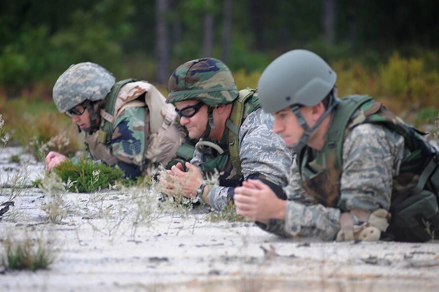 Students partcipating in functional-specific training for the Air Force legal career field learn "low-crawl" techniques during a class on a Fort Dix, N.J., range Oct. 1, 2008.  The functional-specific training for the students of the Air Force legal career field focuses on contingency skills basics, rules of use of force, rules of engagement and expeditionary basics for legal Airmen on deployment. The training is held for three days prior to them attending the Advanced Contingency Skills Training Course taught by the U.S. Air Force Expeditionary Center's 421st Combat Training Squadron on Fort Dix.  (U.S. Air Force Photo/Staff Sgt. Nathan Bevier)