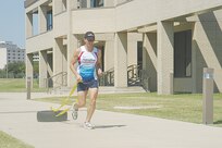 10/3/2008 - James Bales adds more resistance by running with a tire in preparation for the with World Championship Ironman in Kona, Hawaii, on Oct. 11. (USAF photo by Patrick Desmond)                                