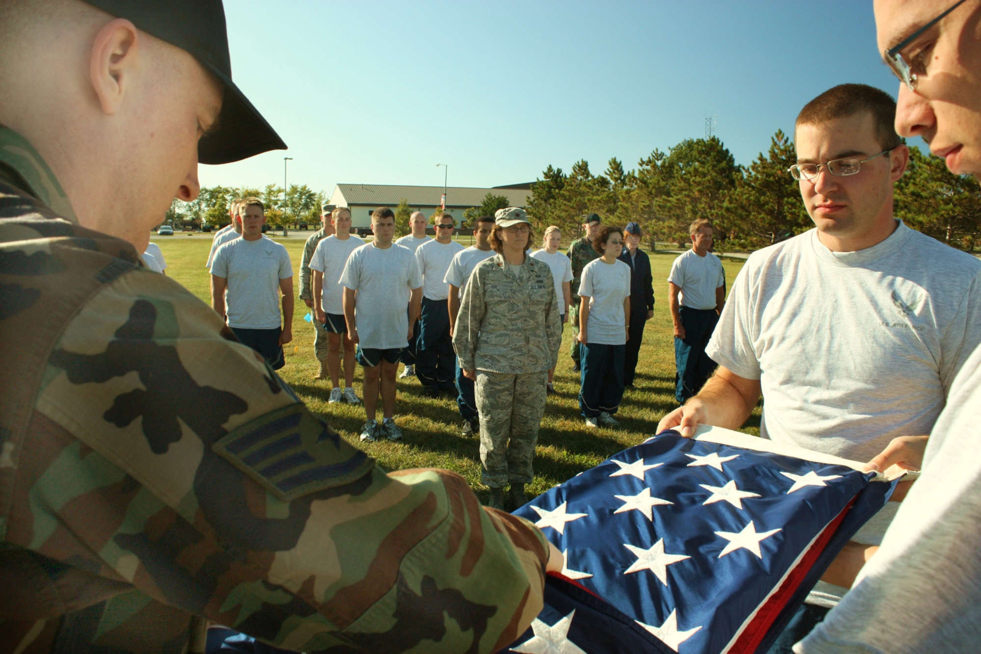 GRISSOM AIR RESERVE BASE, Ind.,-- Members of the 434th Communications Squadron stand at attention while the American flag is folded following a retreat ceremony held during the October unit training asssembly.  Retreat ceremonies are conducted daily at Grissom ARB. (Air Force Photo/Tech. Sgt. Patrick Kuminecz)
