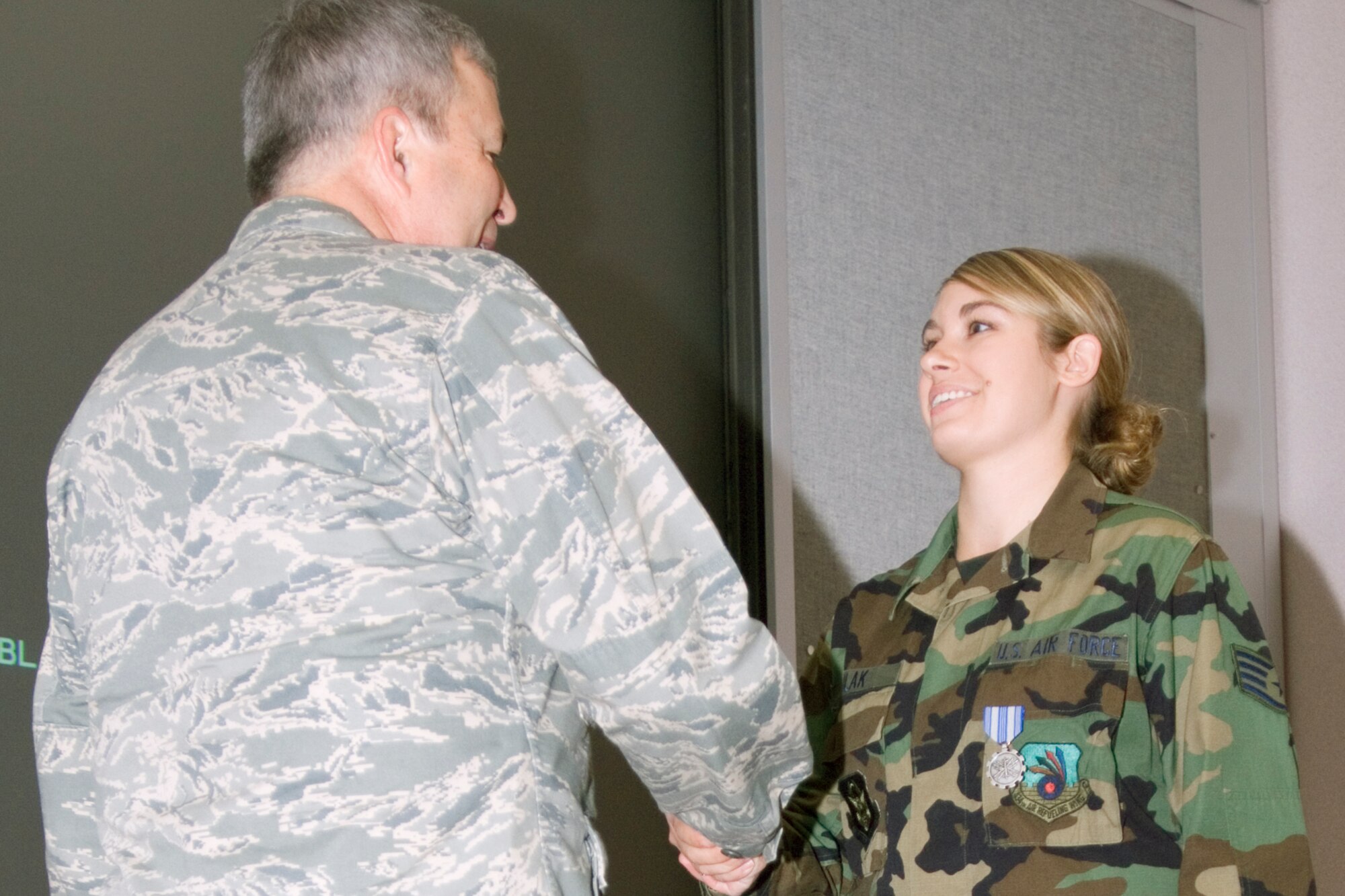 GRISSOM AIR RESERVE BASE, Ind., -- Brig. Gen. Dean Despinoy, 434th Air Refueling Wing commander, presents an Air Force Achievement Medal to Staff Sgt. Krista Kulac, an administrative specialist assigned to the wing staff, during a special ceremony held on the October unit training assembly. (U.S. Air Force photo/Staff Sgt. Mark Orders-Woempner)