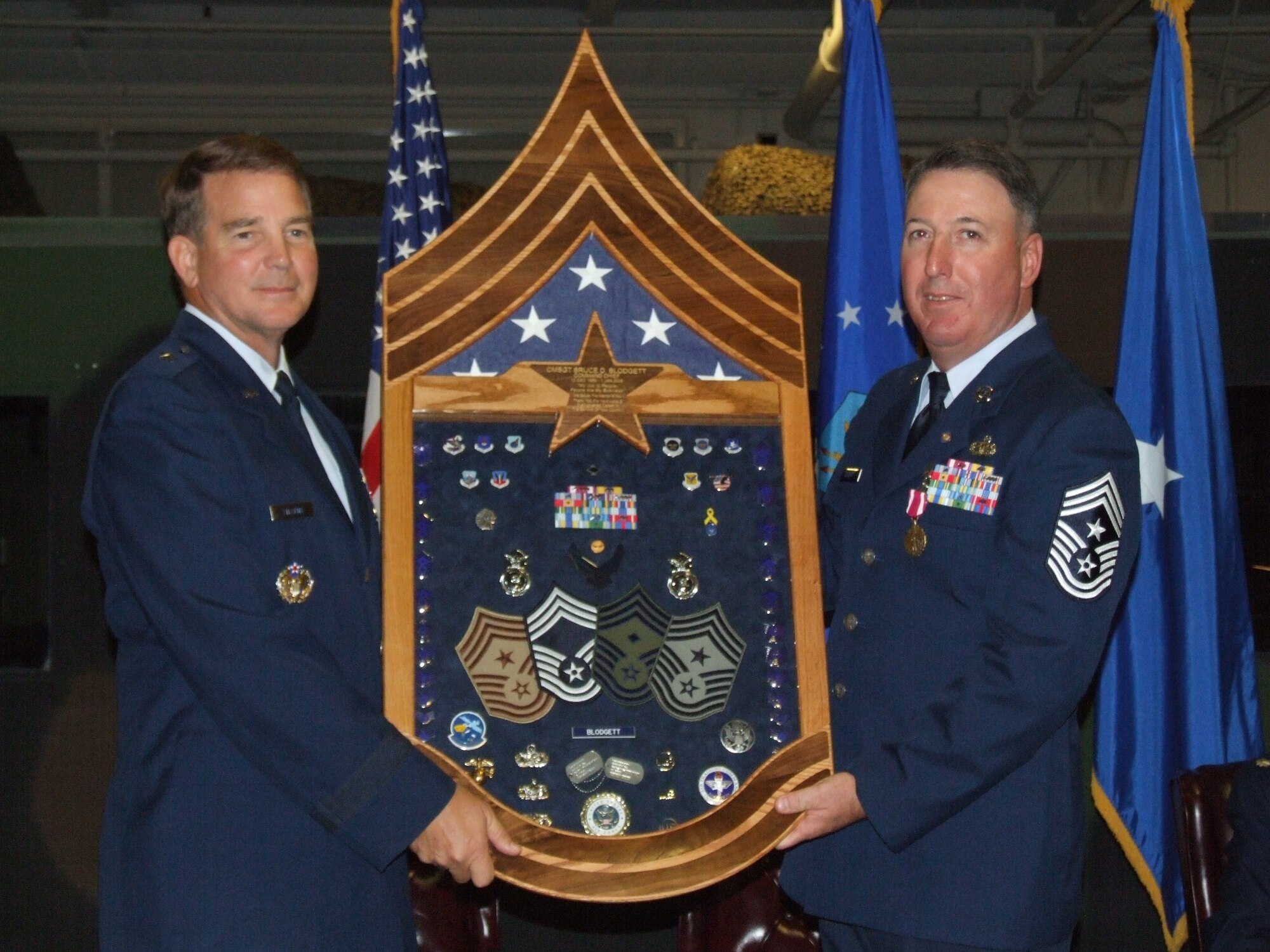 Chief Master Sgt. Bruce Blodgett stands with Brig. Gen. Mark Stearns, 15th Expeditionary Mobility Task Force commander, during his retirement ceremony Oct. 3. Chief Blodgett retired as the 15th EMTF command chief after serving more than 27 years in the Air Force. (U.S. Air Force photo/Senior Airman Charles Slayton)