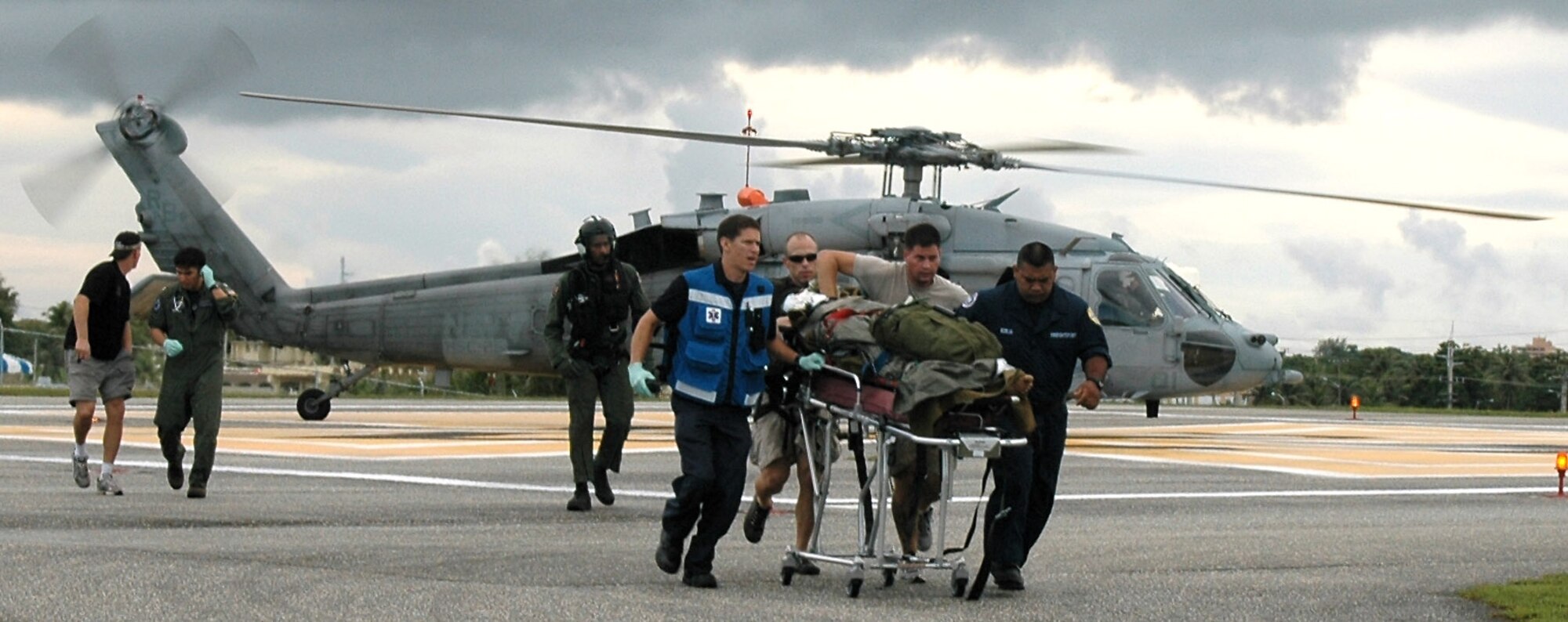 Airmen from the 31st Rescue Squadron at Kadena Air Base, Japan, and other medical personnel offload an injured mariner from a Navy helicopter in Guam Sept. 25. The mariner was rescued from a Panamanian freighter about 750 miles north of Saipan. (U.S. Air Force photo) 