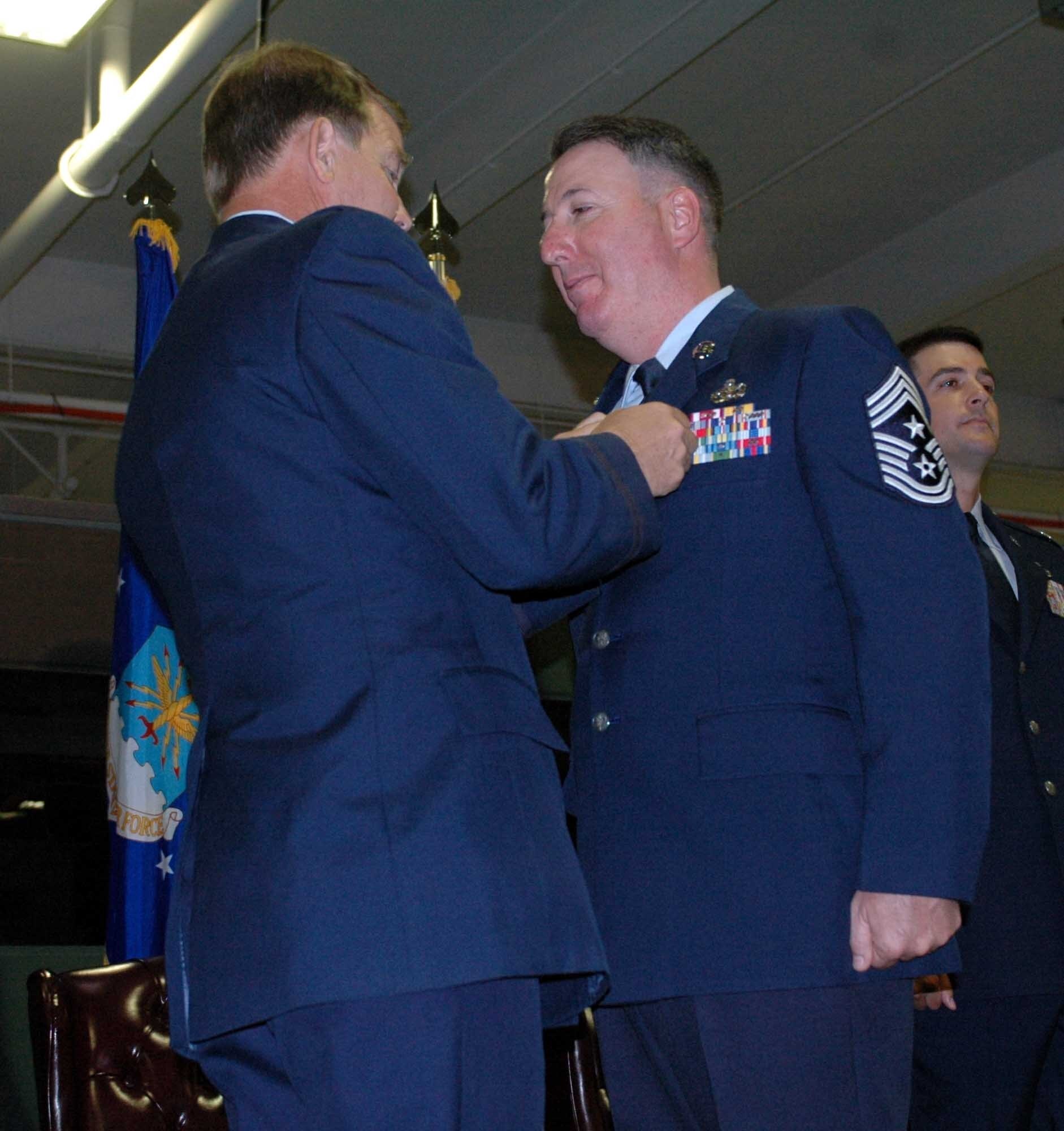 Chief Master Sgt. Bruce Blodgett stands during his retirement ceremony Oct. 3. Chief Blodgett retired as the 15th Expeditionary Mobility Task Force command chief after serving more than 27 years in the Air Force. (U.S. Air Force photo/Airman1st Class Kristen Rohrer)