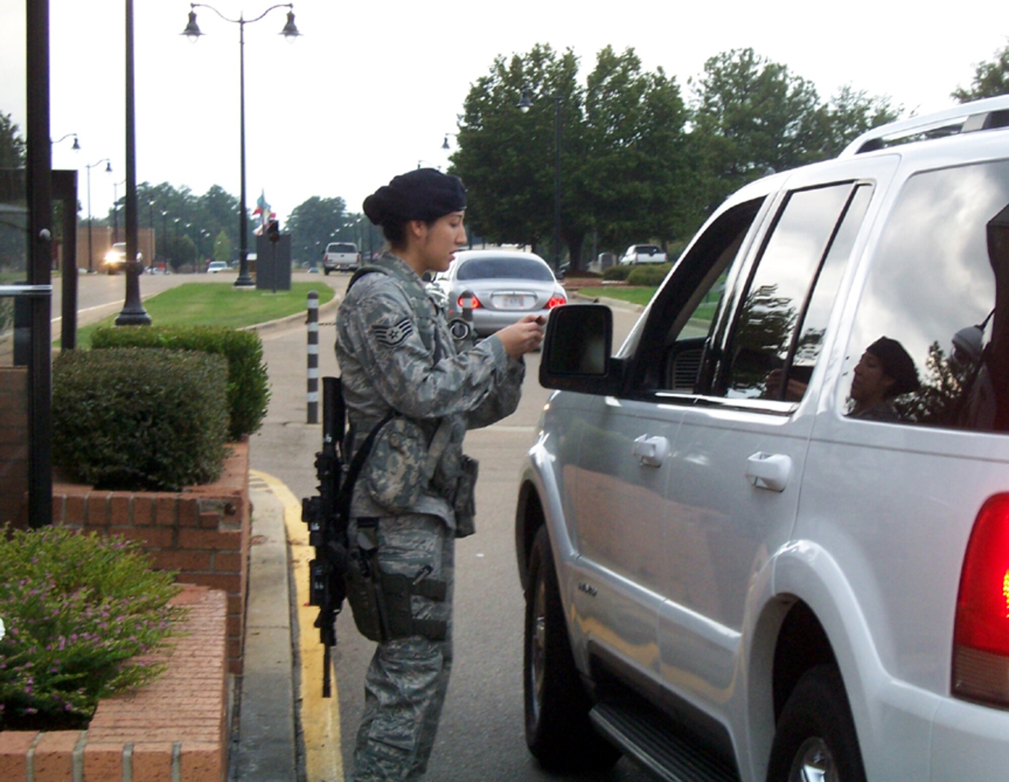 Staff Sgt. Monica Newcomb, 14th Security Forces Squadron, checks an identification card at the main Gate of Columbus AFB Oct 7. Columbus Airmen have returned to Installation Entry Controller duty starting Oct. 1 as they transition to Department of Defense civilians. (U.S. Air Force photo by Sonic Johnson)